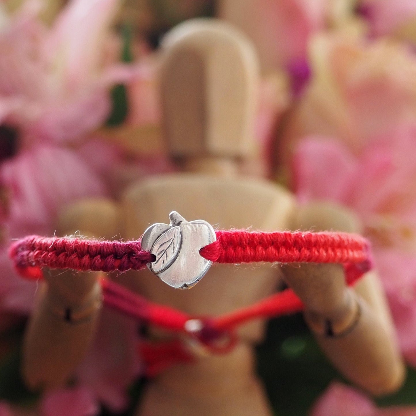 A gorgeous deep red leather and cotton friendship bracelet with a lovely tiny handmade fine silver apple.
