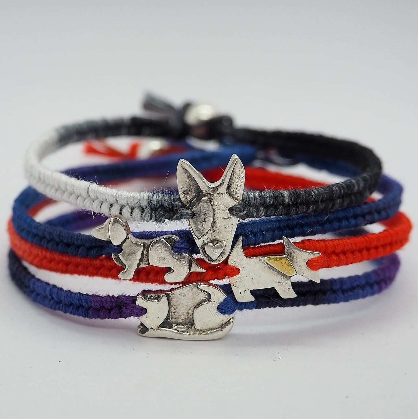 A unique sweet handmade fine silver greyhound dog on a beautiful soft oranges leather, sterling silver and cotton friendship bracelet.