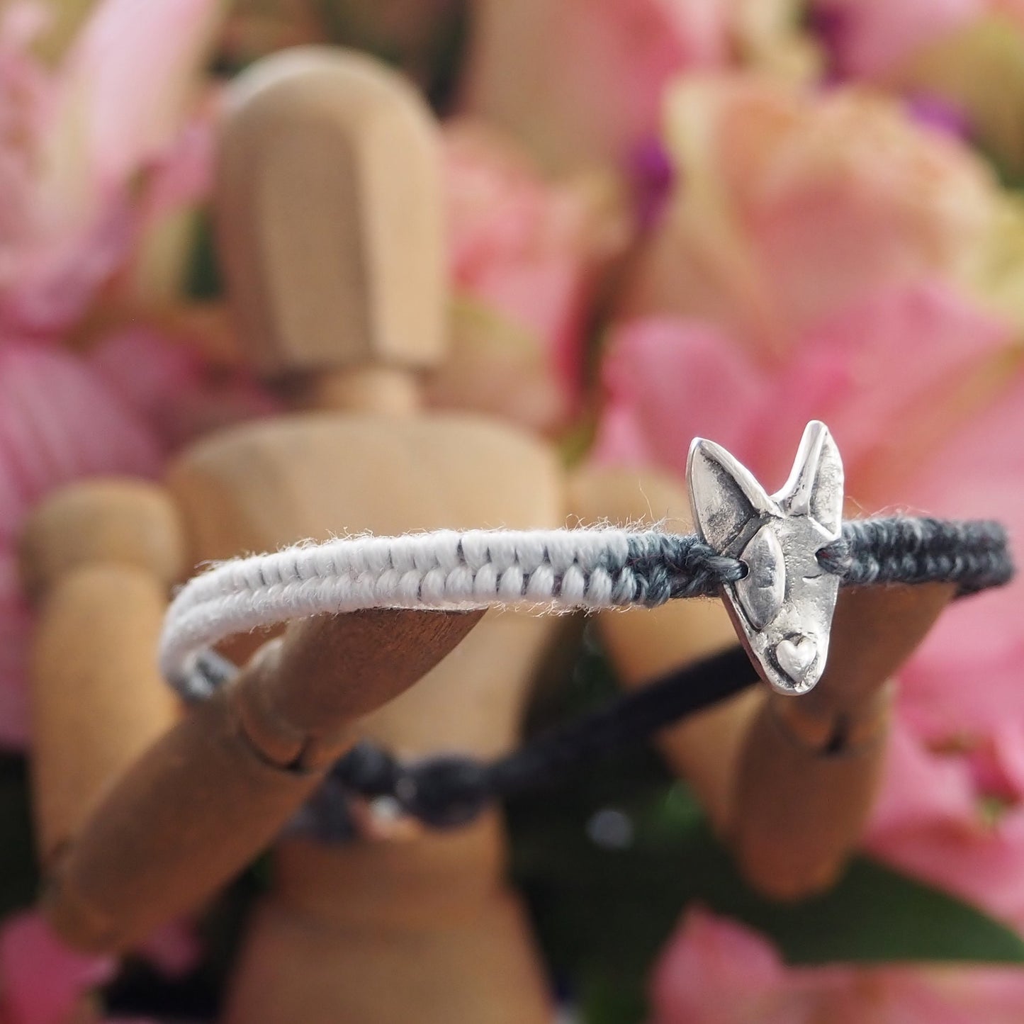 A unique adorable handmade fine silver bull dog on a beautiful grey and black leather, sterling silver and cotton friendship bracelet.