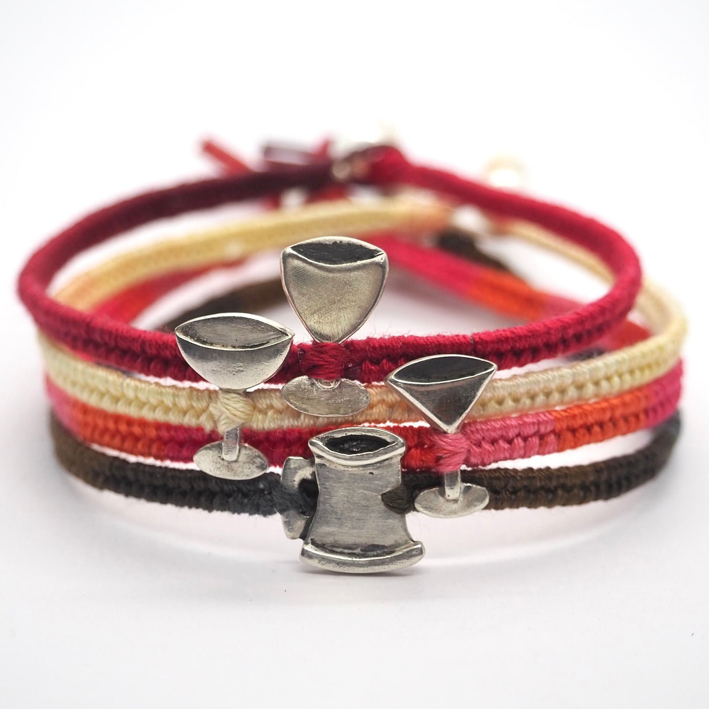 A Guinness coloured friendship bracelet with a handmade fine silver cheer tankard on cotton and leather with a sterling silver bead