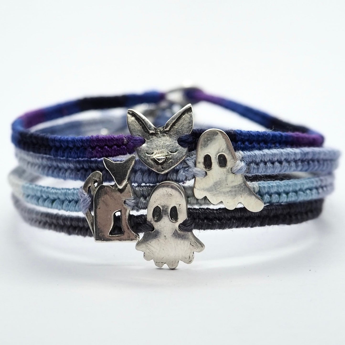 A wonderful deep blue and purple leather, sterling silver and cotton friendship bracelet with a tiny unique fine silver Siamese cat.