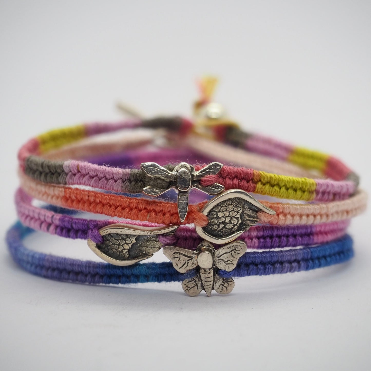 A gorgeous peachy leather, cotton and sterling silver friendship bracelet with a little handmade fine silver angel wing.