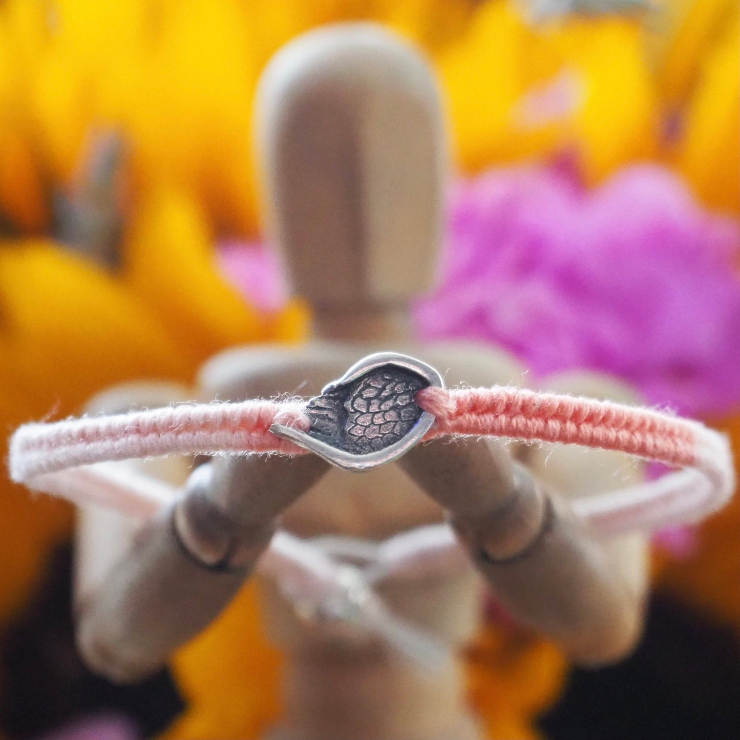 A gorgeous peachy leather, cotton and sterling silver friendship bracelet with a little handmade fine silver angel wing.