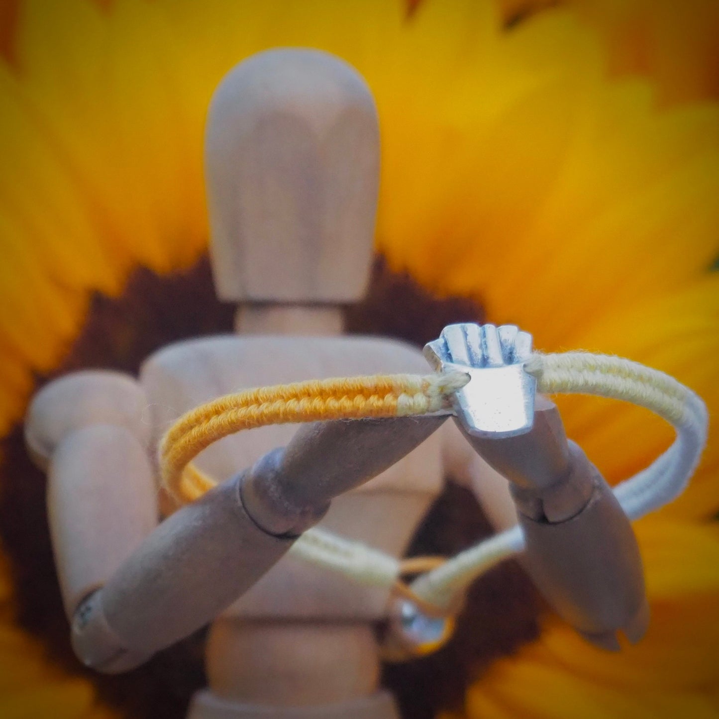 A unique tiny fine silver portion of fries on a beautiful yellow leather, sterling silver and cotton friendship bracelet.