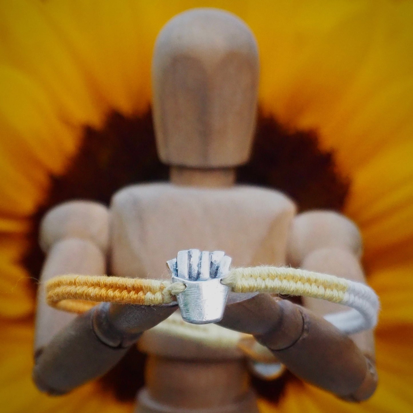A unique tiny fine silver portion of fries on a beautiful yellow leather, sterling silver and cotton friendship bracelet.