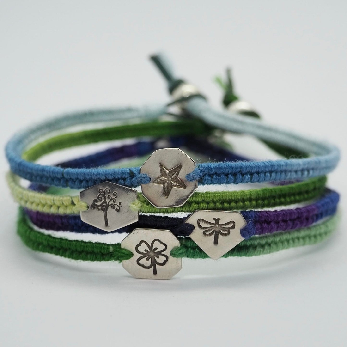 A hand cut sterling silver hexagonal disc hand stamped with a nautical star on a gorgeous soft blues leather and cotton friendship bracelet.