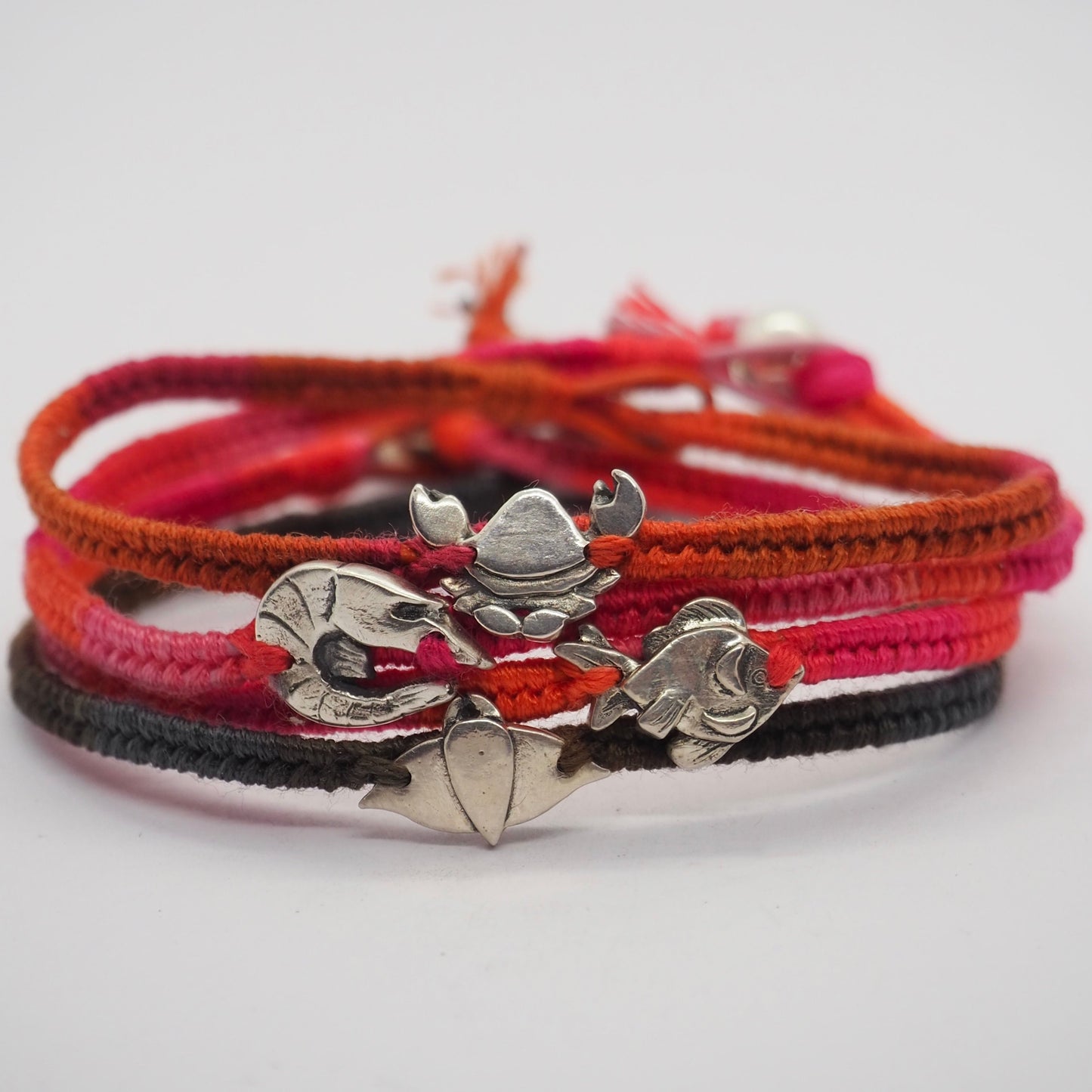 A gorgeous goldfish hand made in fine silver on a soft reddy orange leather, cotton and sterling silver friendship bracelet.