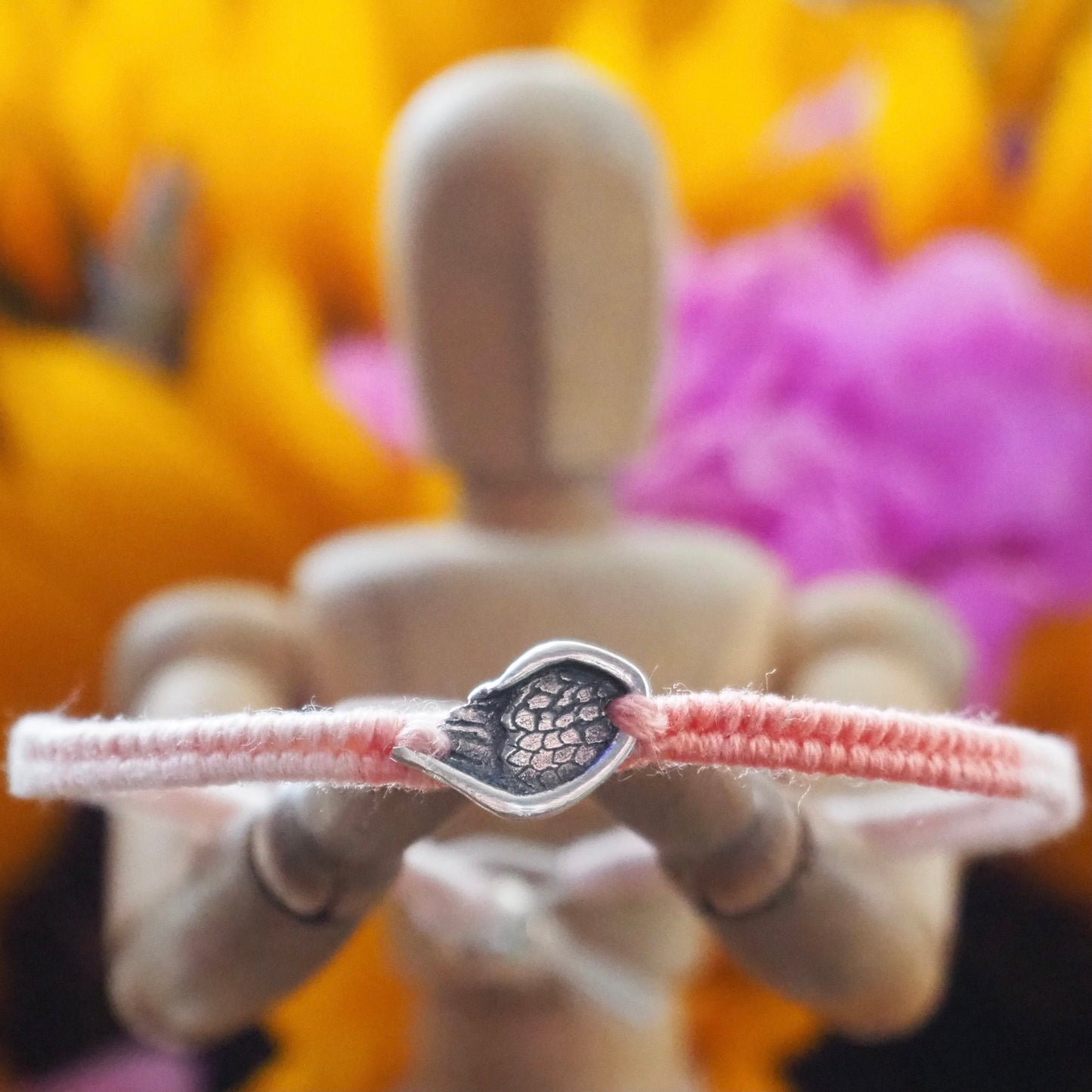 A gorgeous peachy leather, cotton and sterling silver friendship bracelet with a little handmade fine silver angel wing.