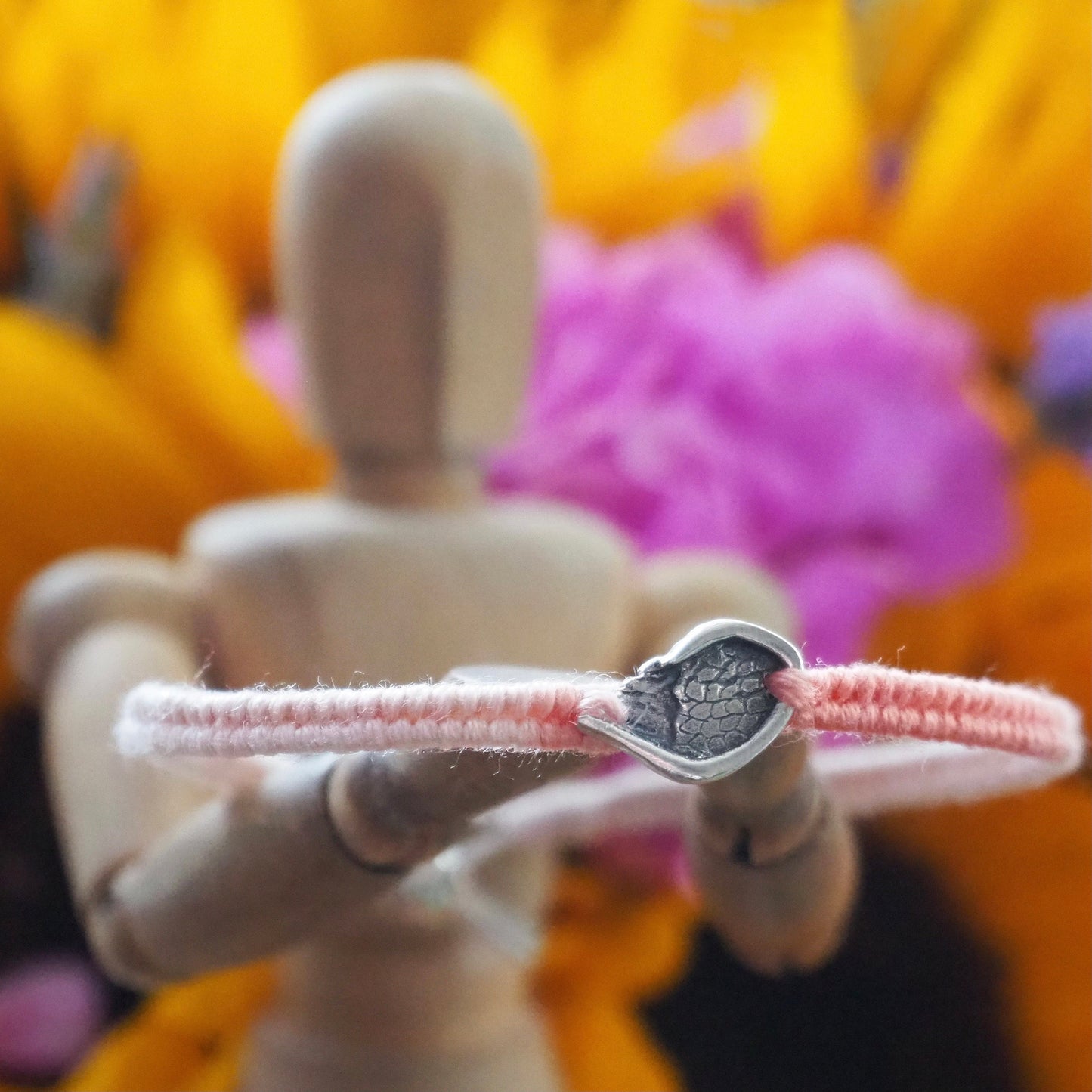 A gorgeous peachy leather, cotton and sterling silver friendship bracelet with a little handmade fine silver angel wing.