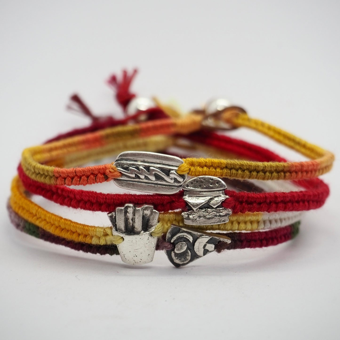 A unique tiny fine silver portion of fries on a beautiful yellow leather, sterling silver and cotton friendship bracelet.