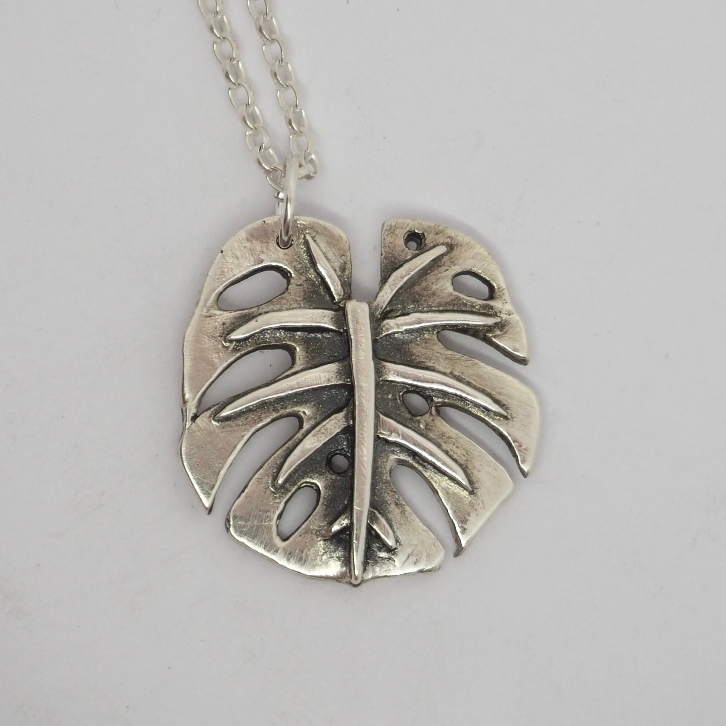 A gorgeous unique small size monstera leaf handmade in eco friendly fine silver on a sterling silver necklace.