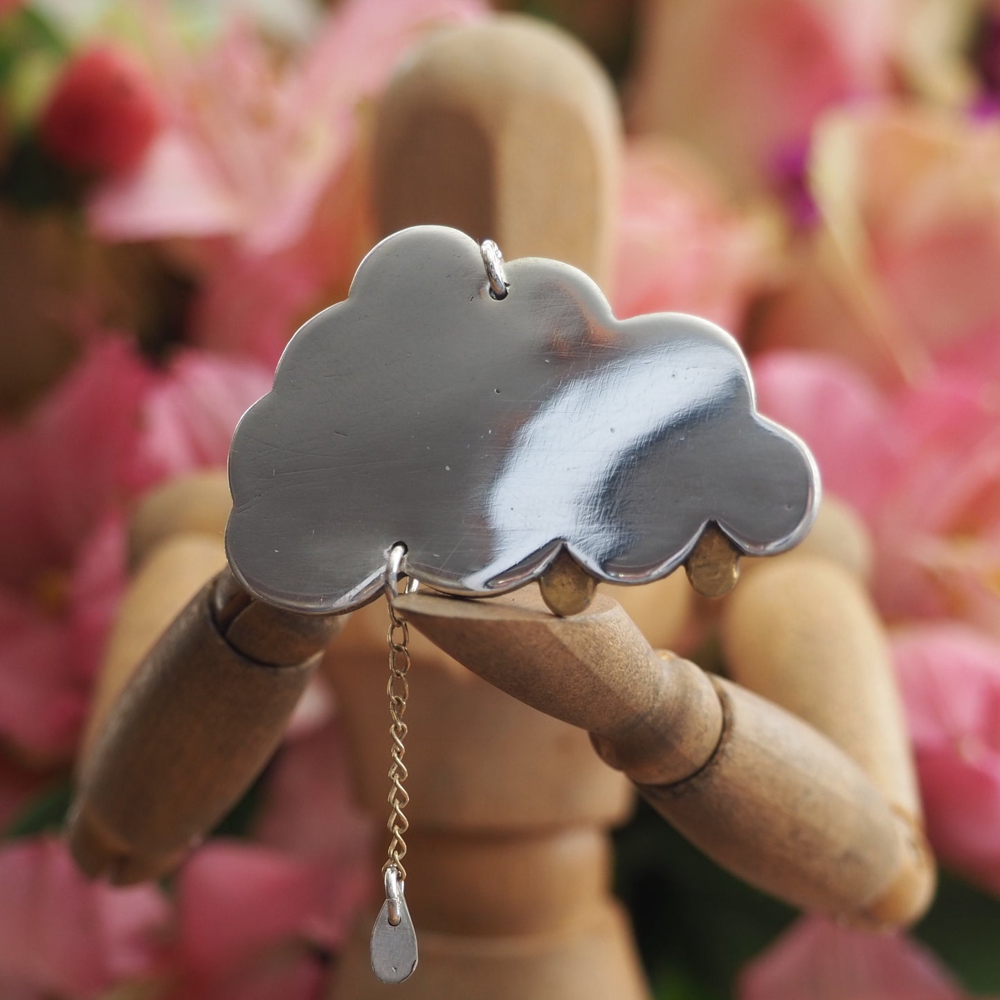 A simply adorable fine silver cloud pendant with tiny golden raindrops, one hung from 9ct gold chain hung on a sterling silver chain.