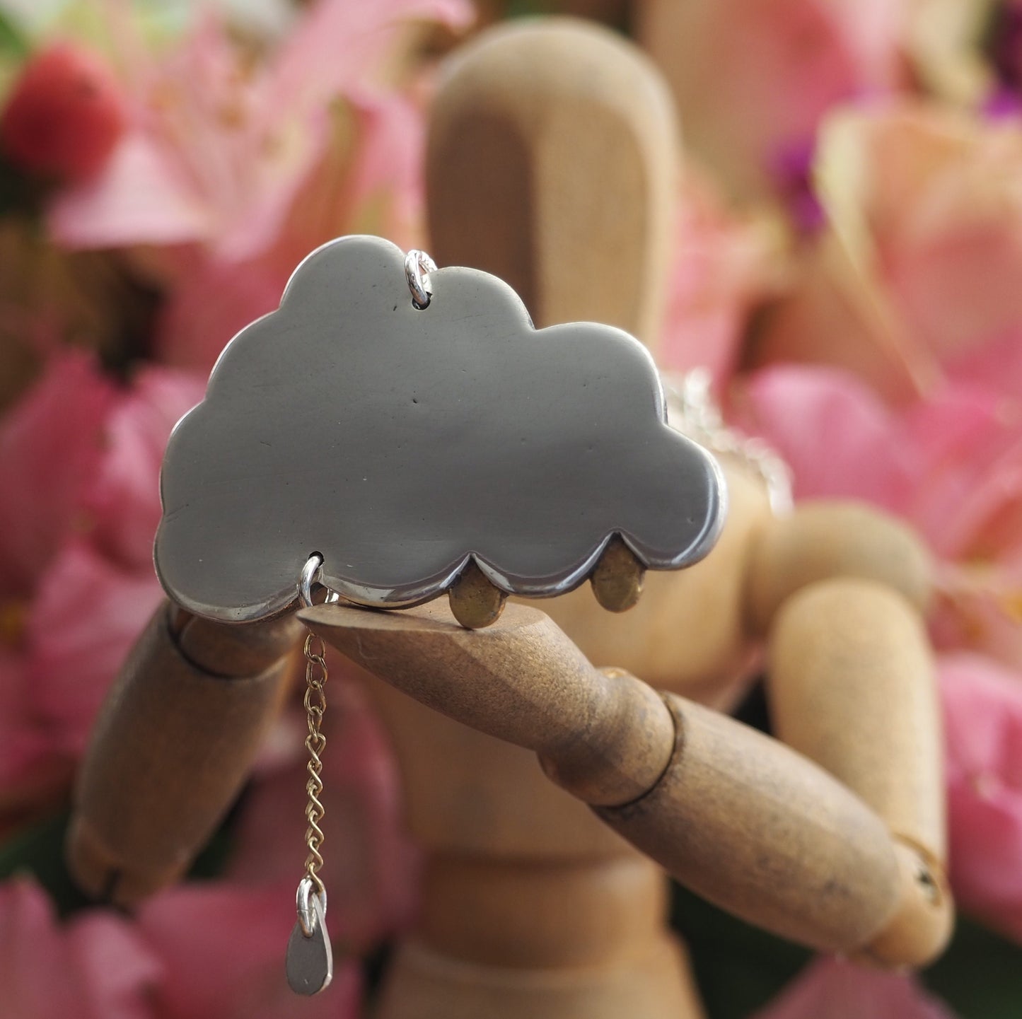 A simply adorable fine silver cloud pendant with tiny golden raindrops, one hung from 9ct gold chain hung on a sterling silver chain.