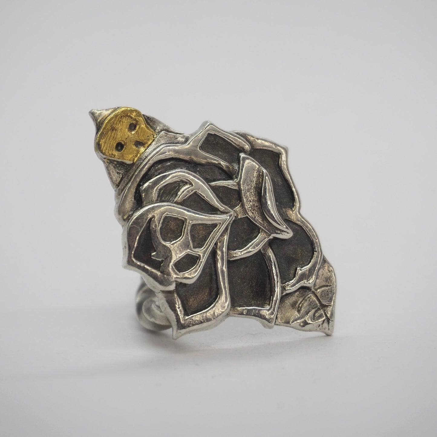 A gorgeous fine silver hand made tattoo style rose ring set on a pretty hand twisted sterling silver band.