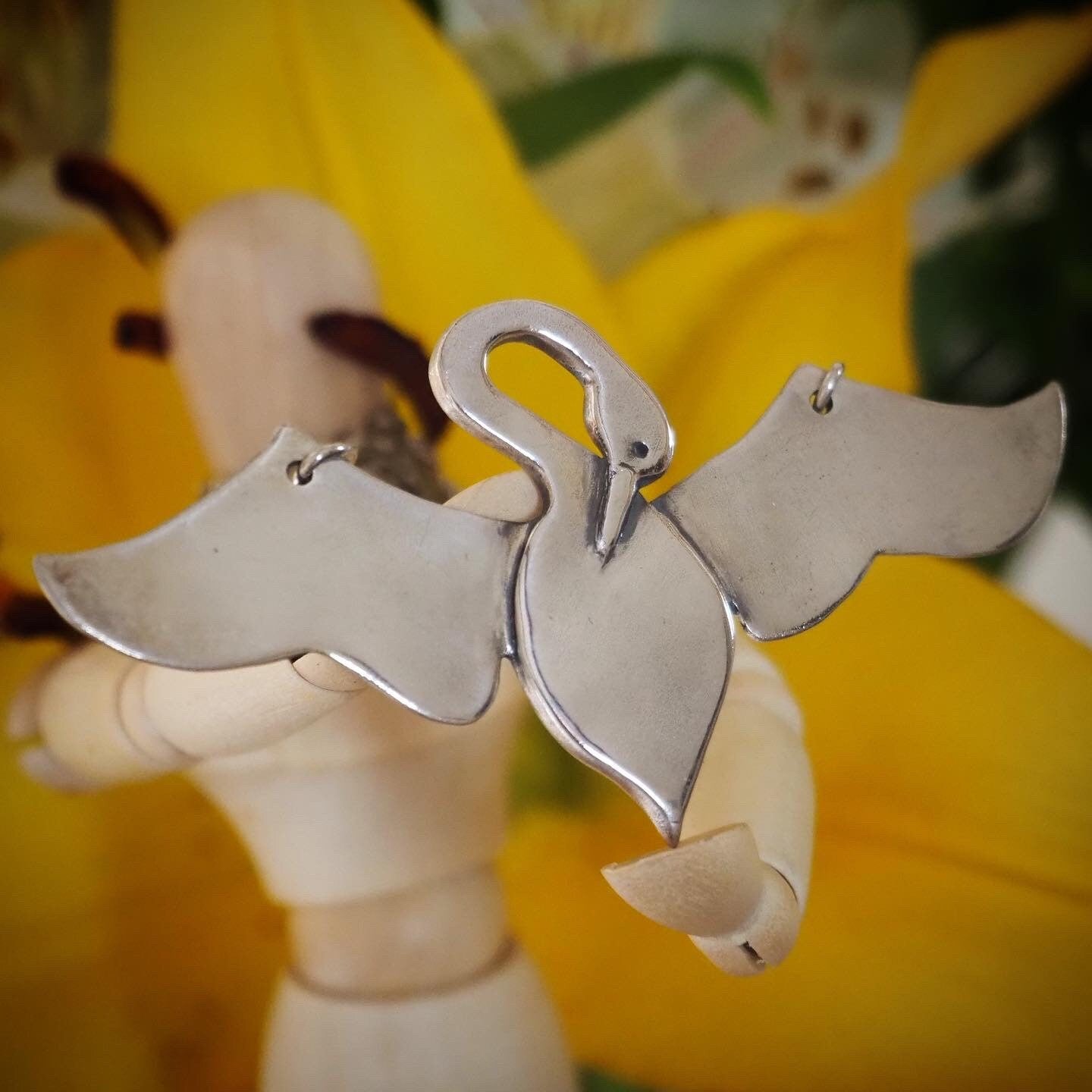 A unique and beautifully simple flying swan necklace, handmade in fine silver on a sterling silver chain.