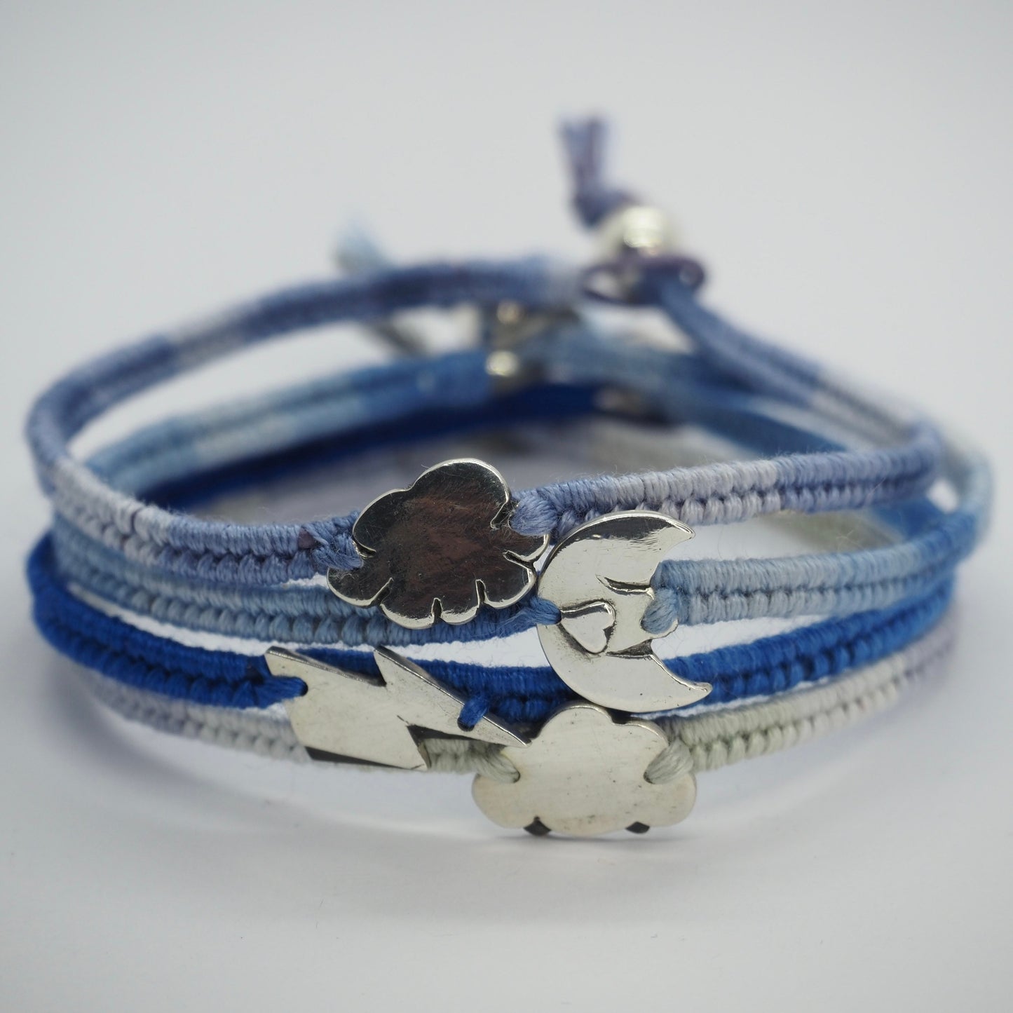 A pretty little cloud charm hand made in fine silver on a soft bluey grey leather, cotton and sterling silver friendship bracelet.