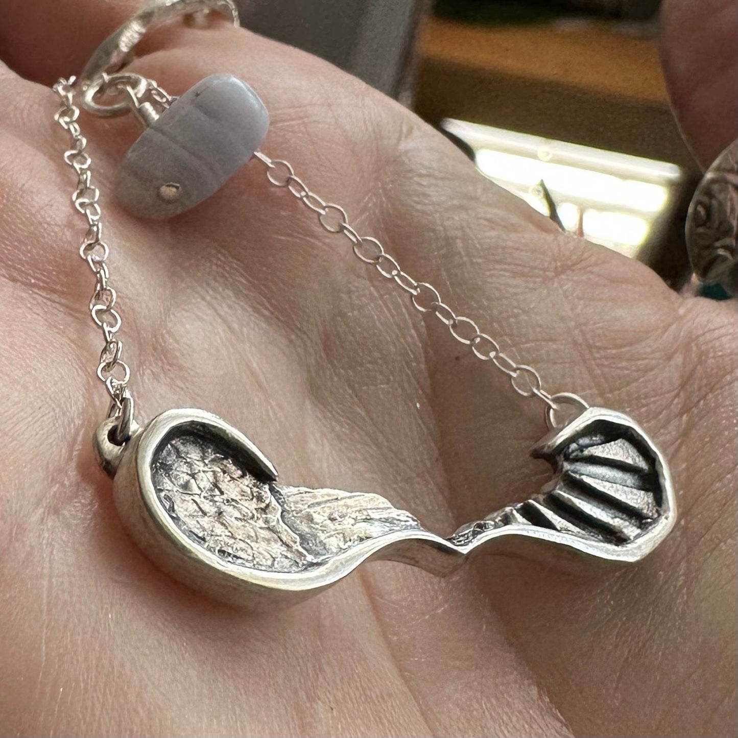 A gorgeously simple fine silver pair of handmade angel and devil wings necklace on a sterling silver chain.