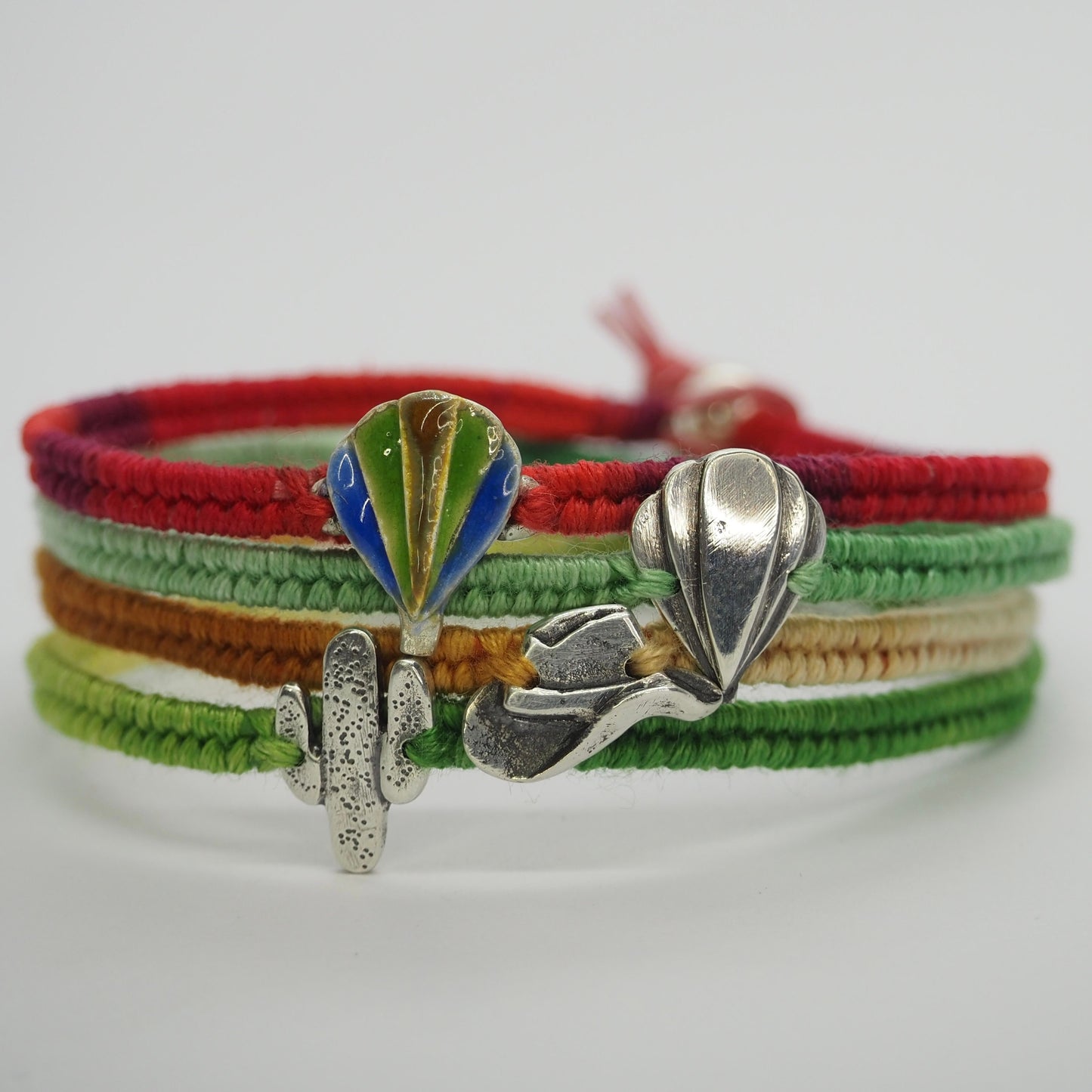 A beautiful green leather, cotton and sterling silver friendship bracelet with a fine silver hot air balloon .