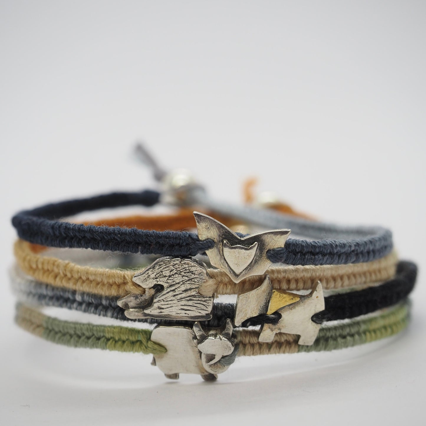 A stunning little fine silver hedgehog on a beautiful soft brown leather, sterling silver and cotton friendship bracelet.