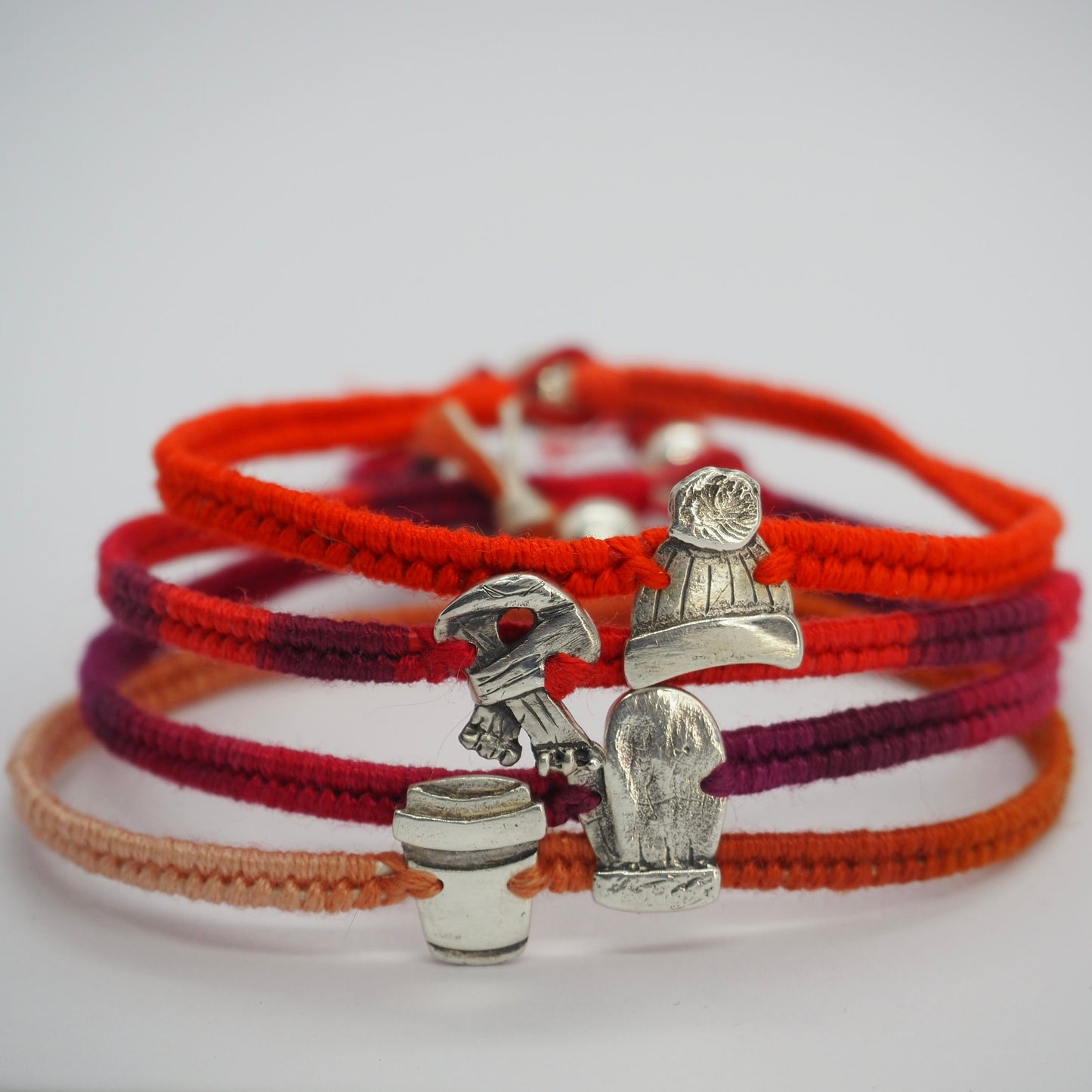 A sweet tiny handmade fine silver scarf on a gorgeous bright red leather, cotton and sterling silver friendship bracelet.