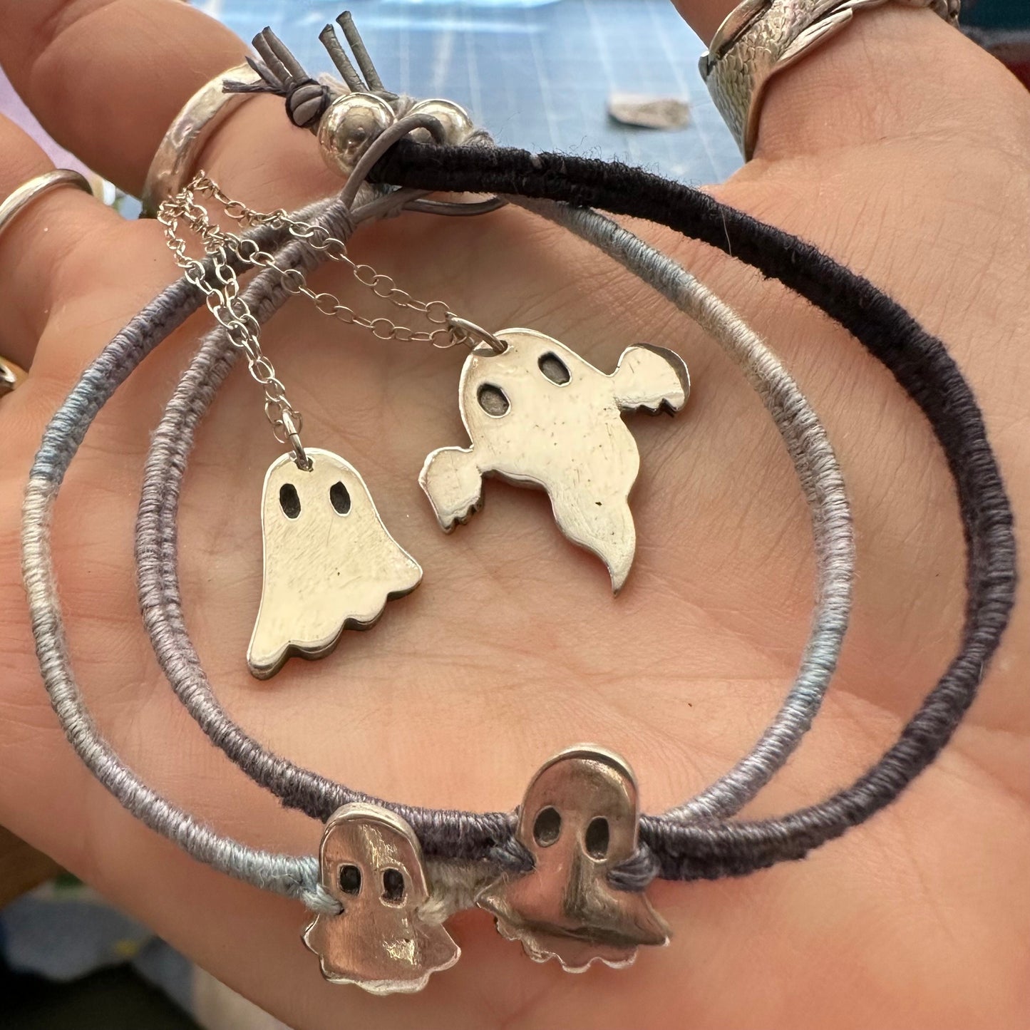 A cute little ghost pendant handmade in fine silver on a sterling silver chain.