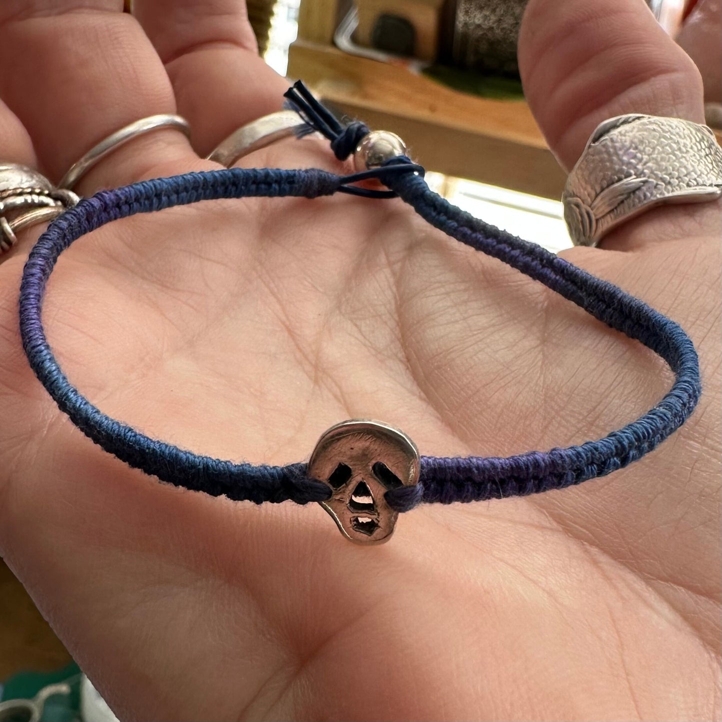 A wonderfully gothic tiny unique fine silver skull on a blues and purples leather, sterling silver and cotton friendship bracelet.