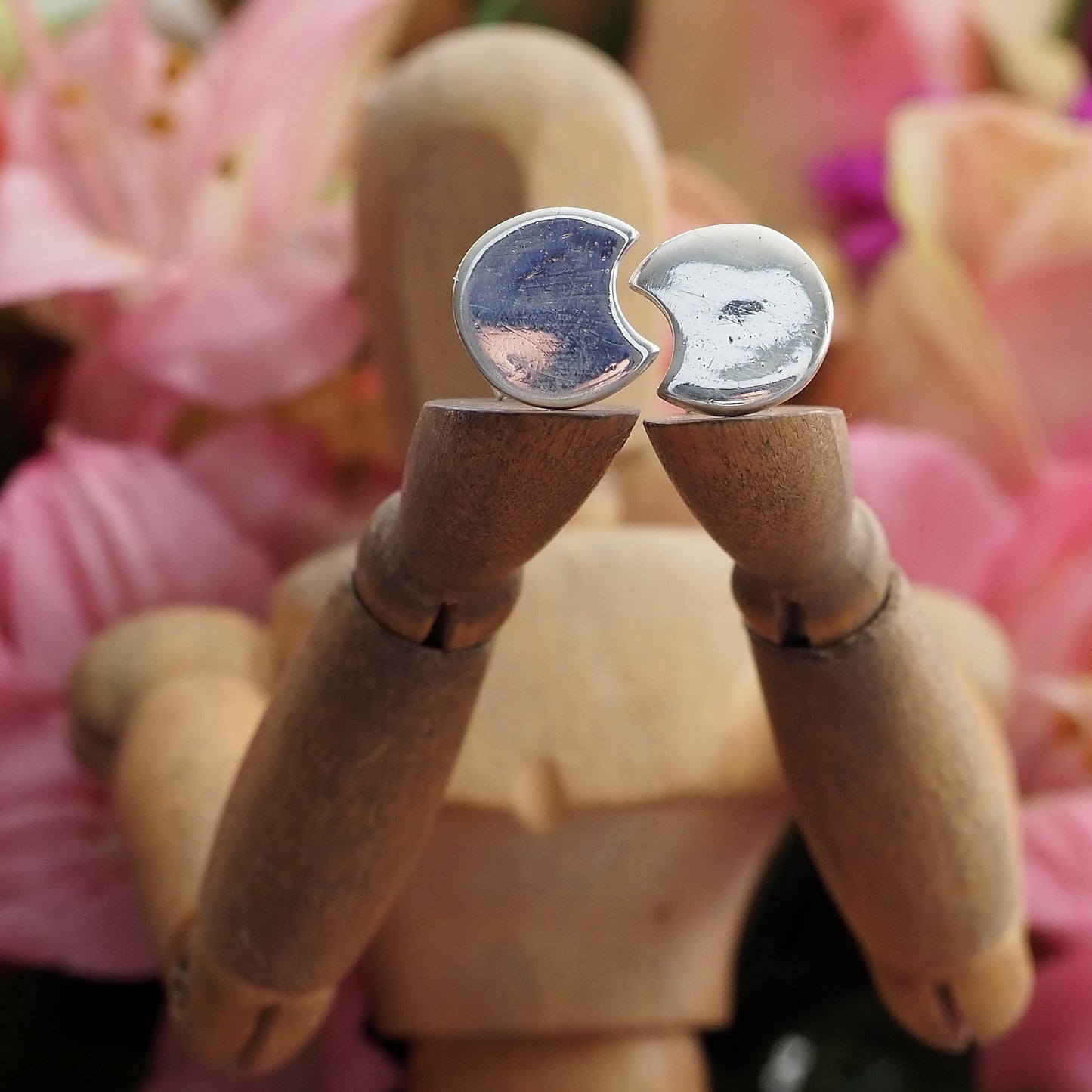 A stunning pair of tiny fine silver moon stud earrings on sterling silver posts.