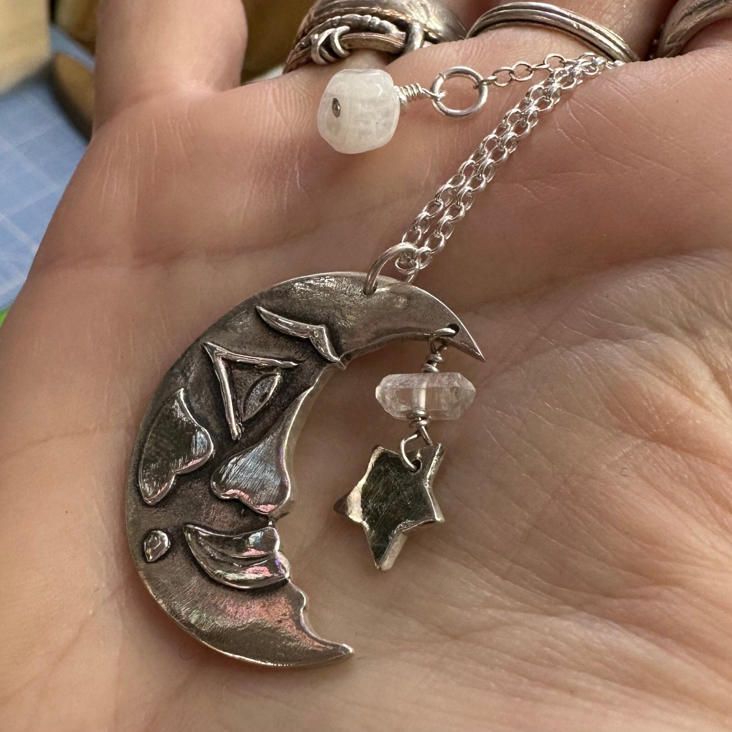 A beautiful handmade fine silver moon and star pendant on a sterling silver chain embellished with a Herkimer diamond.