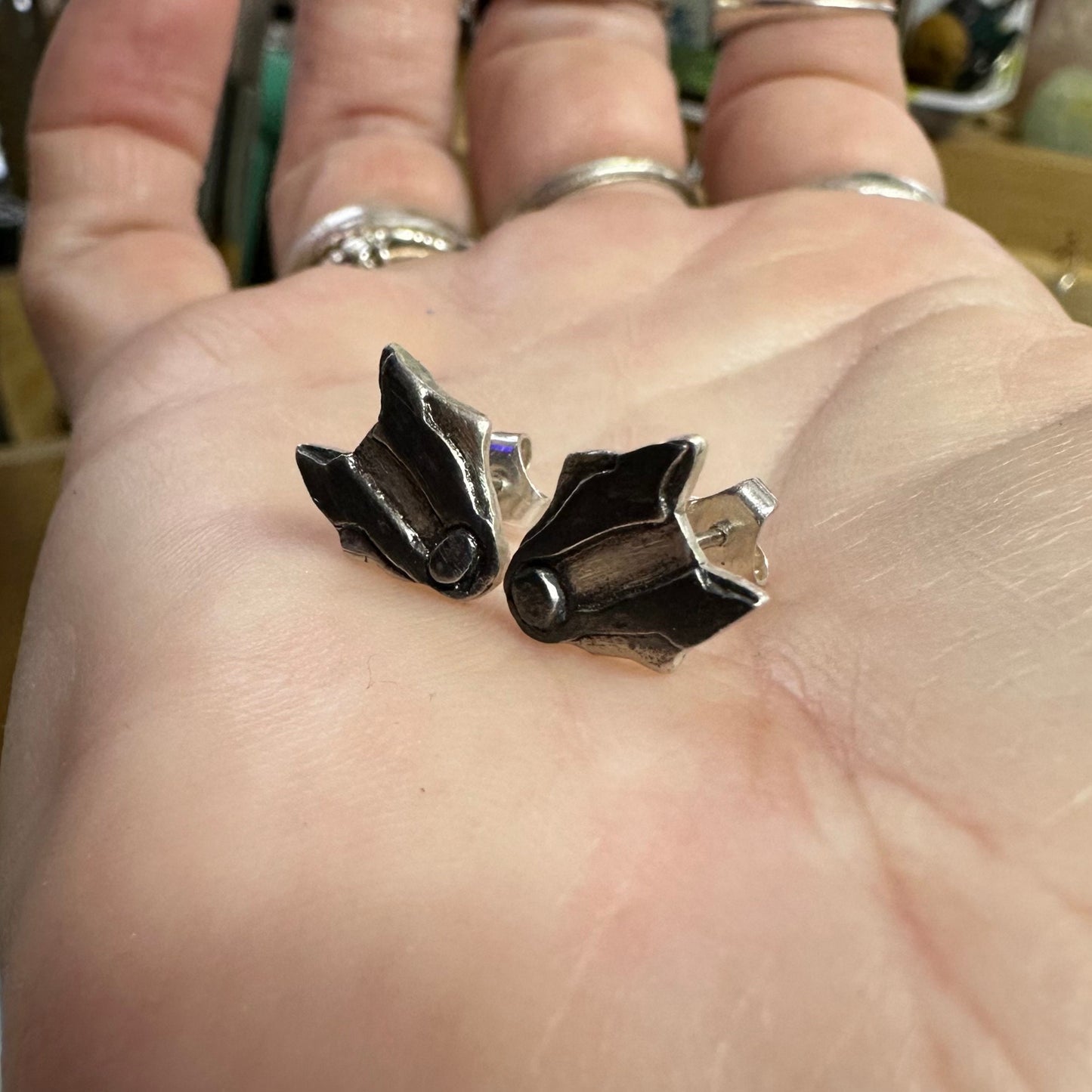 A lovely pair of tiny handmade fine silver badger stud earrings set on sterling silver pins.