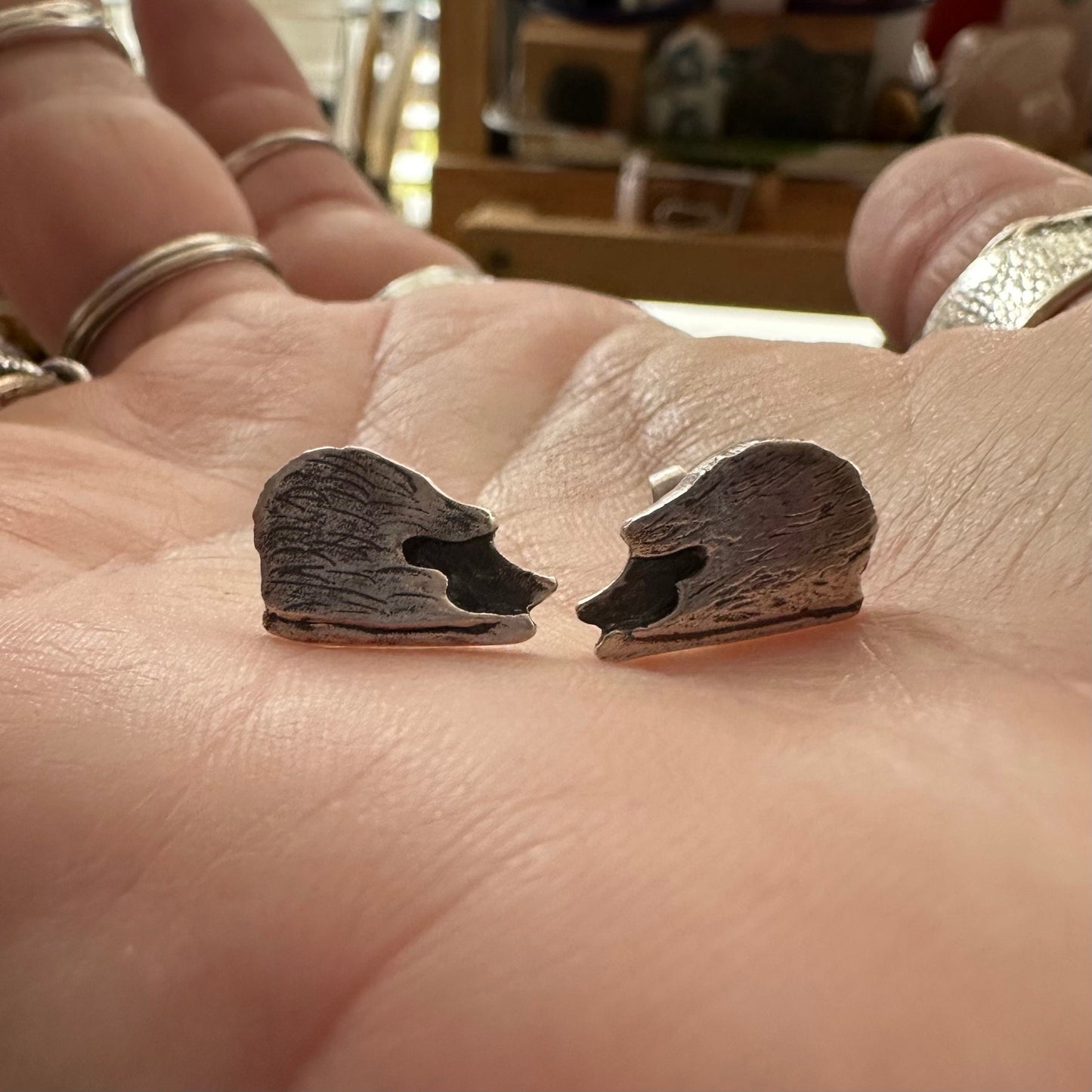 A lovely pair of tiny handmade fine silver hedgehog stud earrings set on sterling silver pins.