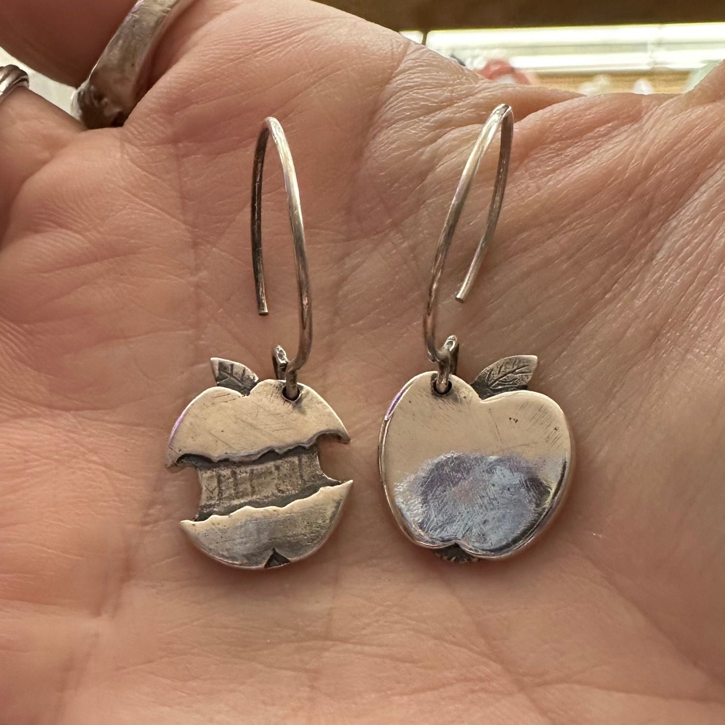 A delightful simple pair of apple and core earrings handmade in solid silver hung on sterling silver hooks.