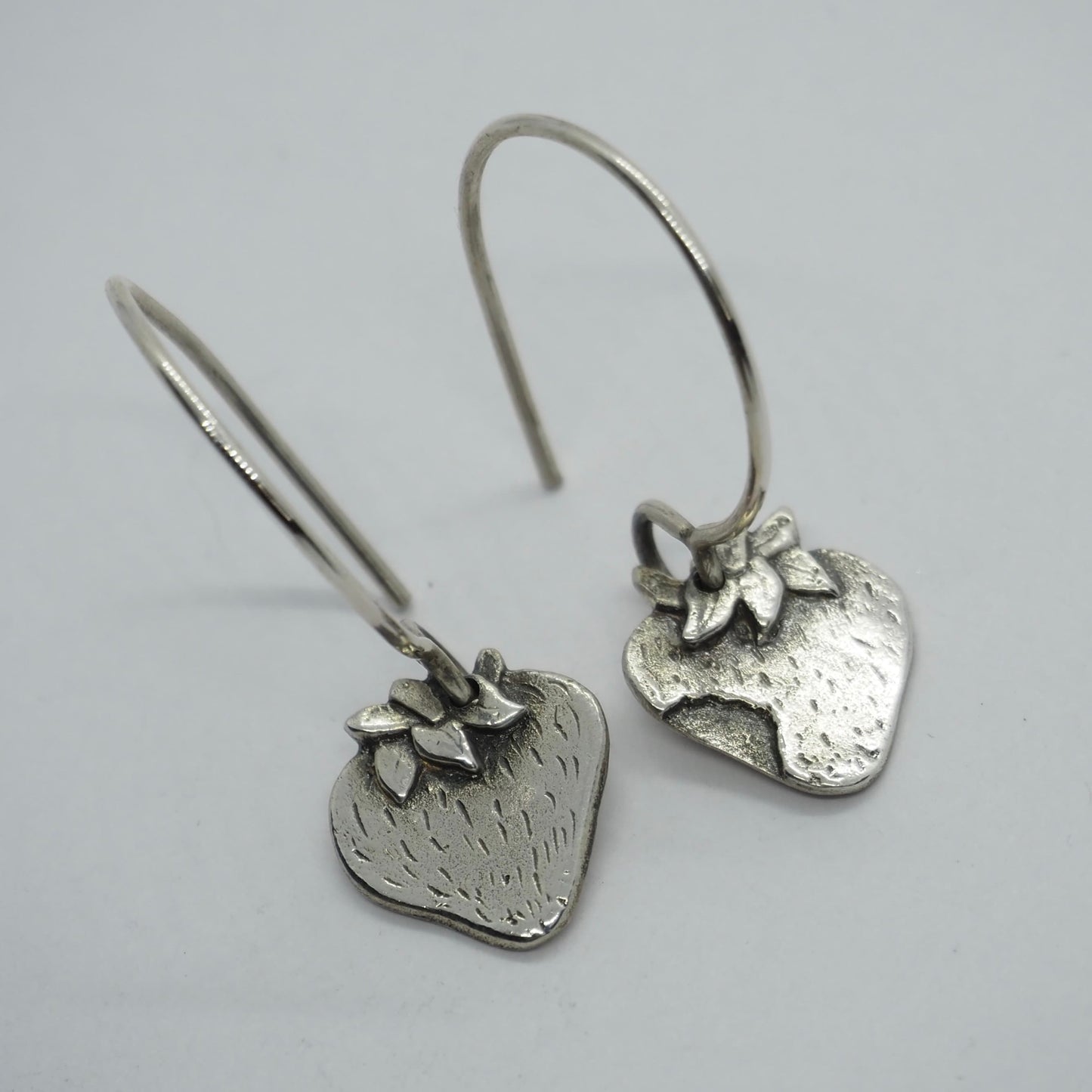 A cute simple solid silver strawberry earrings in solid silver on sterling silver hooks.