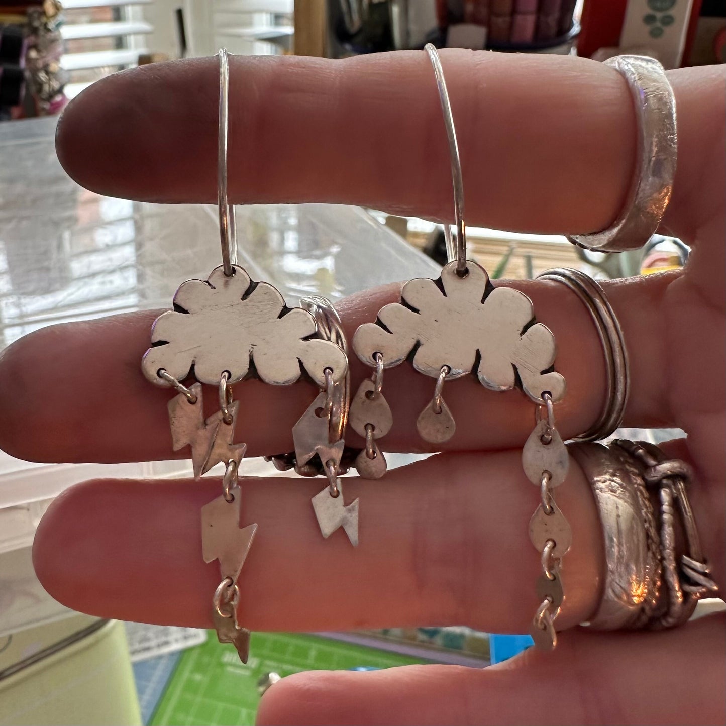 A delightful pair of cloudy weather earrings handmade in fine silver and hung on large handmade sterling silver hoops.