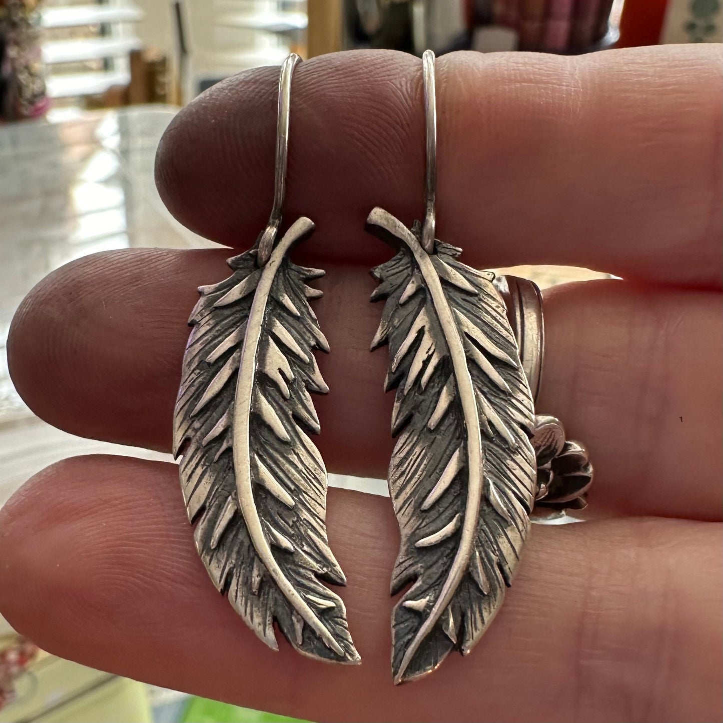 A wonderful pair of handmade fine silver curved feathers on sterling silver wires