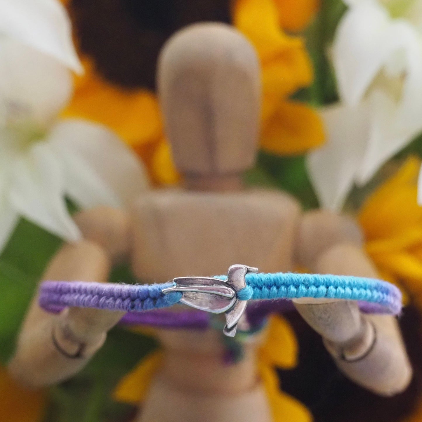 A lovely fine silver humming bird on a cute purple and turquoise leather, sterling silver and cotton friendship bracelet.