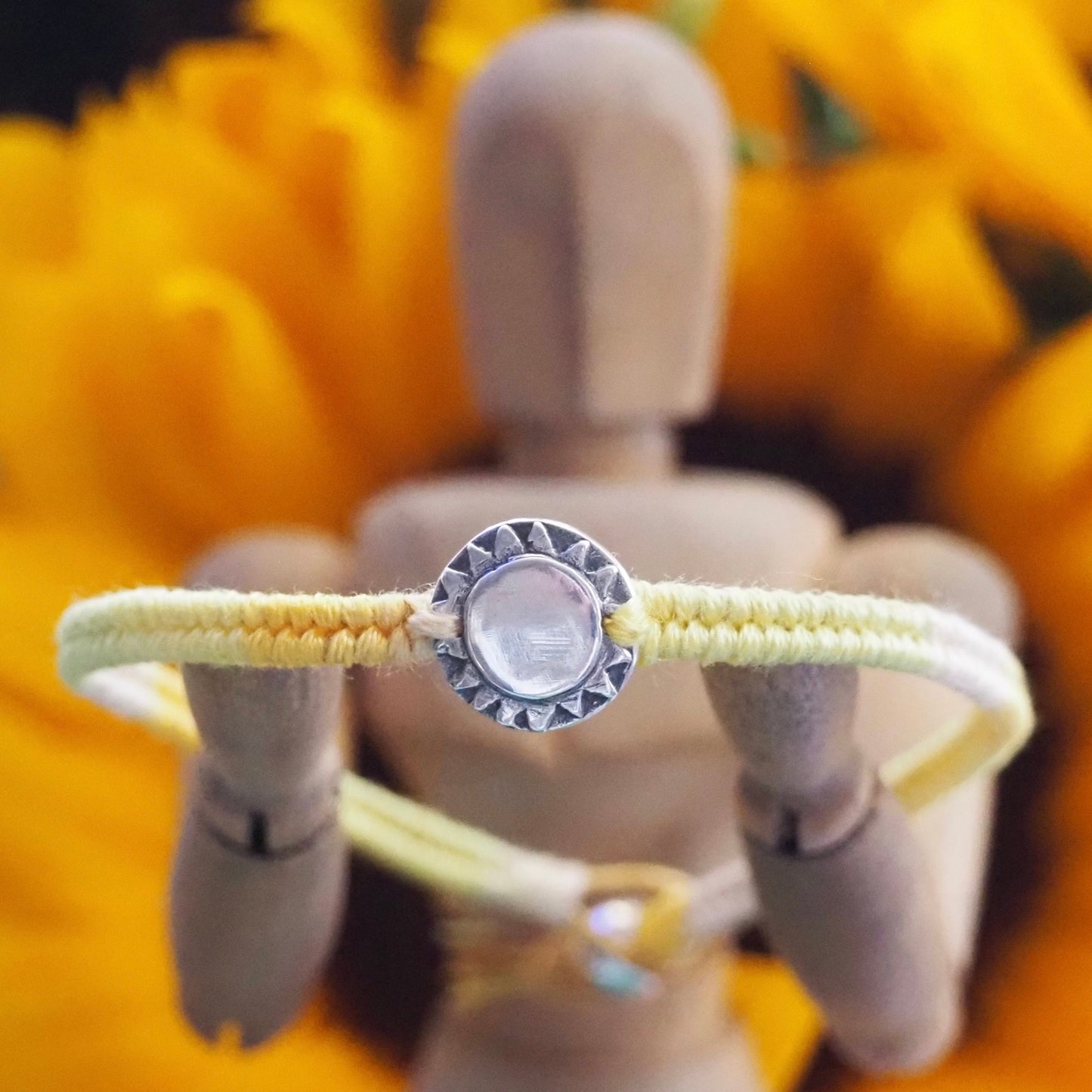 A beaming sun handmade in fine silver on a gorgeous yellow, orange, friendship bracelet in leather, cotton and sterling silver.