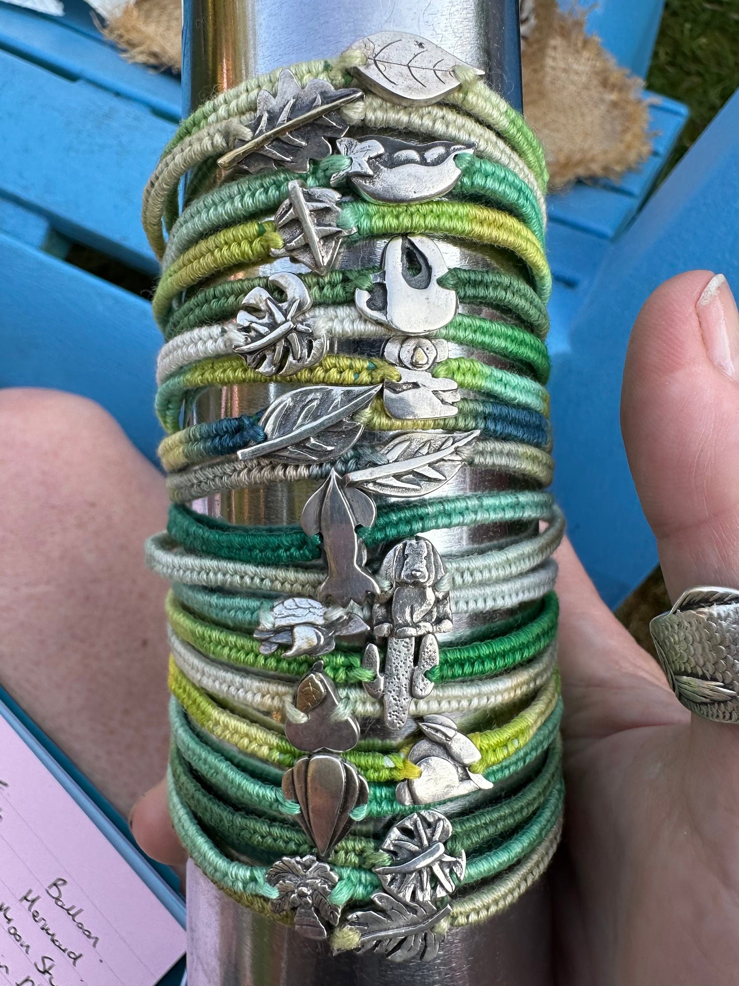 A lovely handmade fine silver sloth on a beautiful green leather, sterling silver and cotton friendship bracelet…