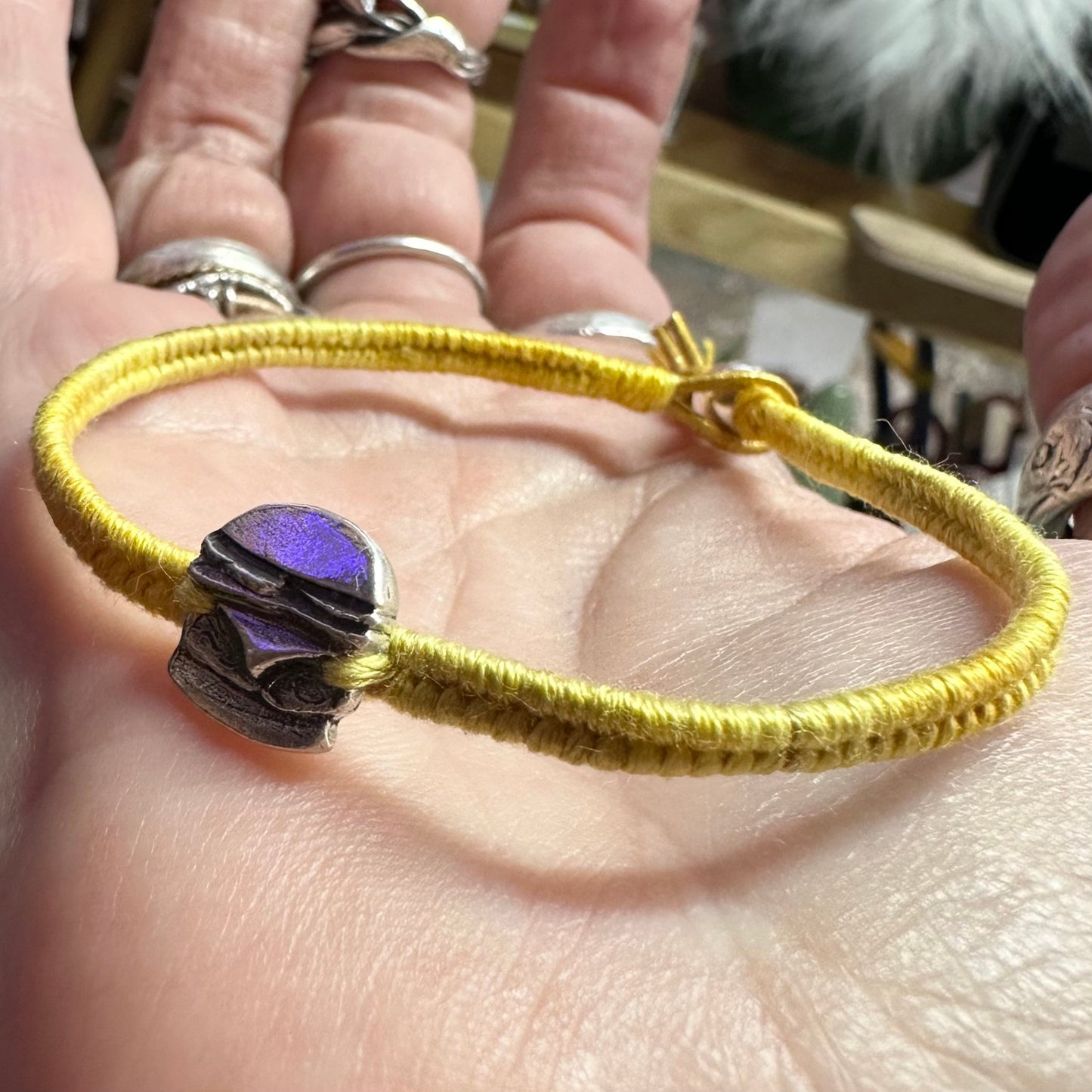 A unique tiny fine silver burger charm on a beautiful yellow leather, sterling silver and cotton friendship bracelet.