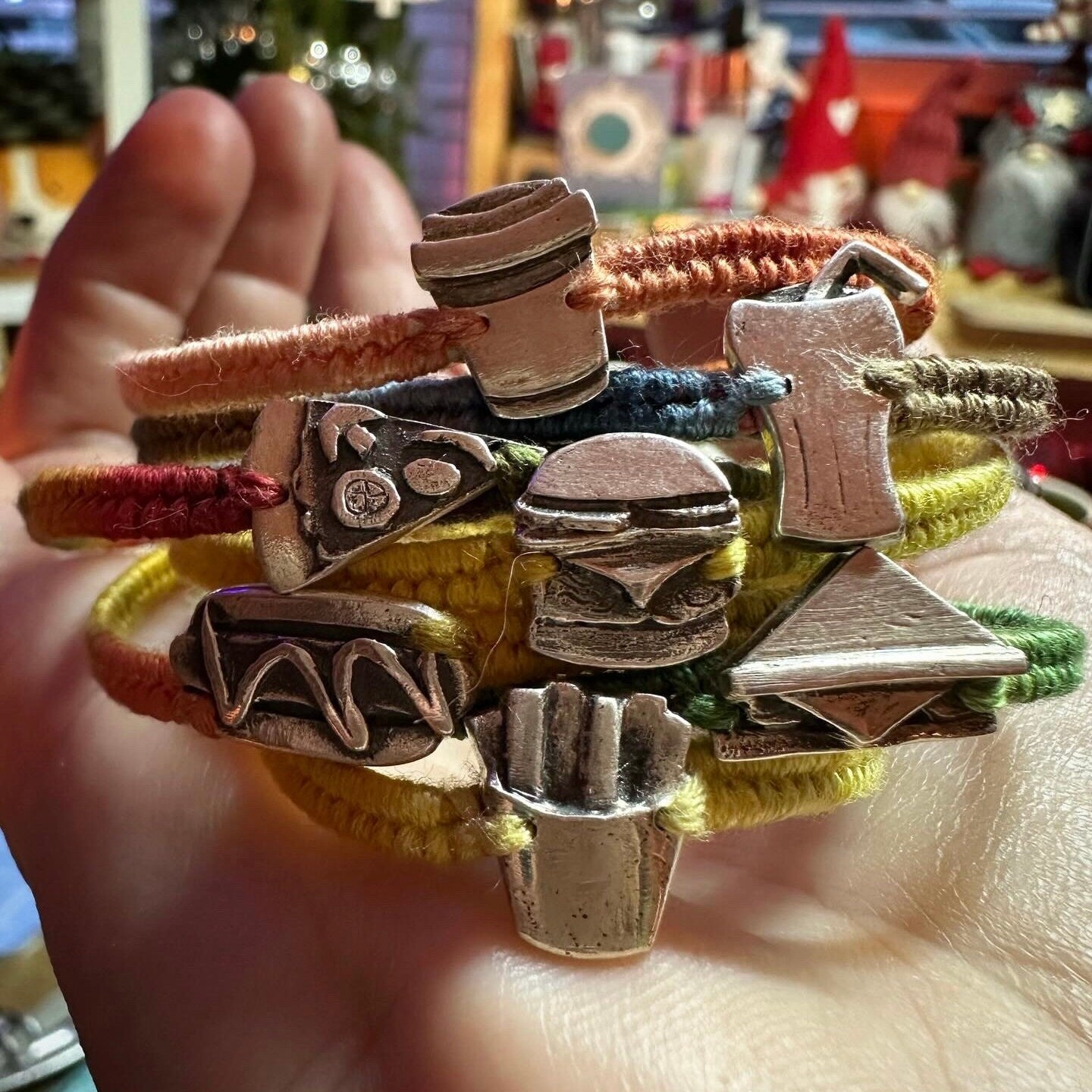 A unique tiny fine silver hot dog on a beautiful mustard and orange leather, sterling silver and cotton friendship bracelet.