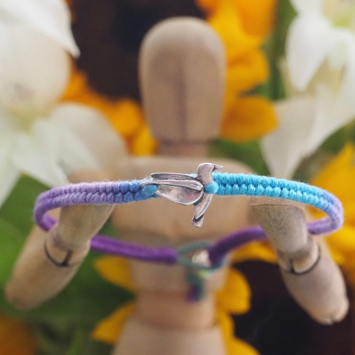 A lovely fine silver humming bird on a cute purple and turquoise leather, sterling silver and cotton friendship bracelet.