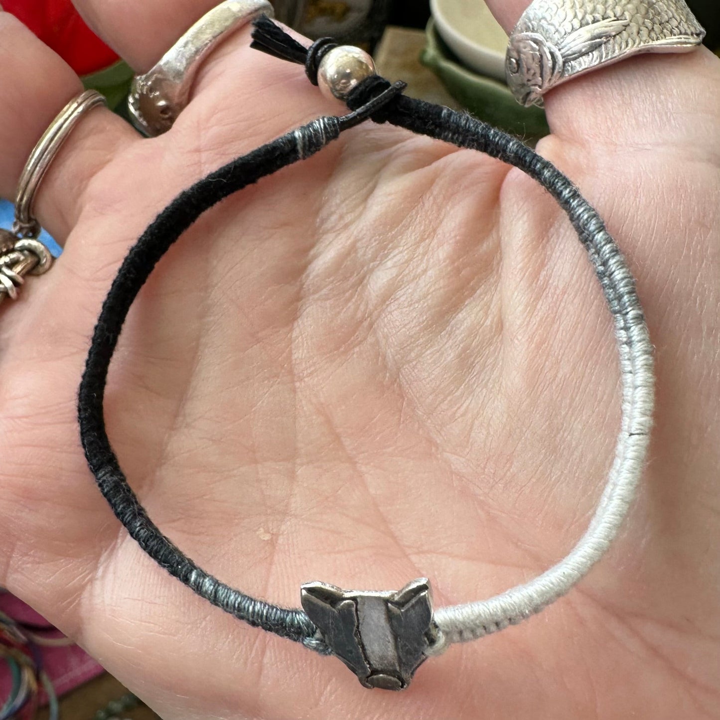 A lovely handmade fine silver badger on a soft black and grey leather, cotton friendship and sterling silver bracelet…