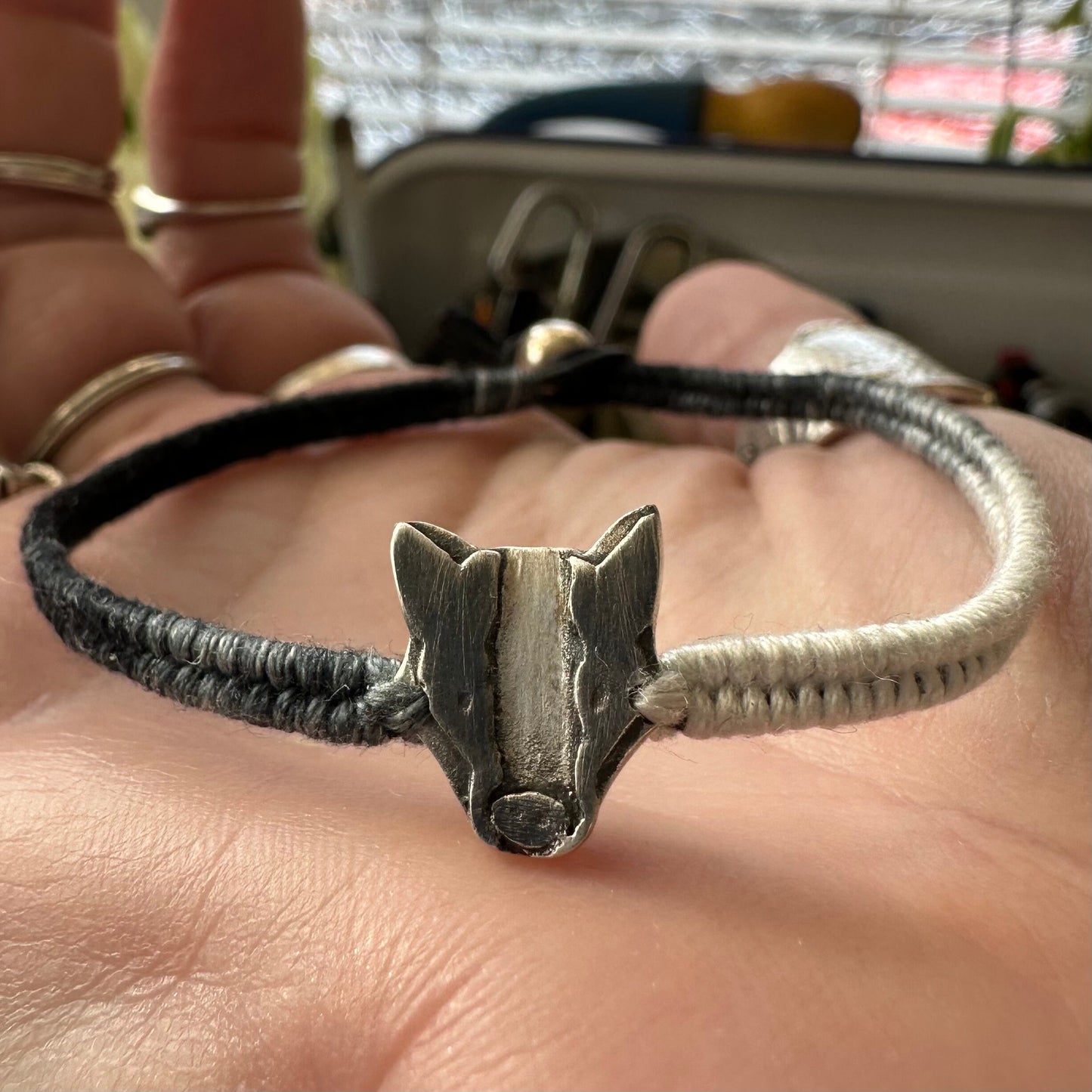 A lovely handmade fine silver badger on a soft black and grey leather, cotton friendship and sterling silver bracelet…