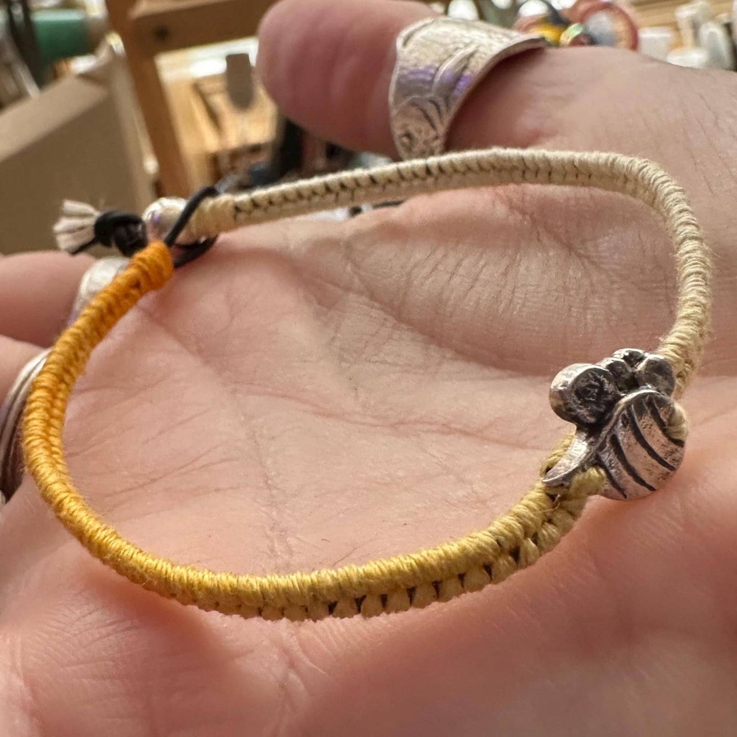 A beautiful little bumble bee handmade in fine silver on a soft yellow leather, sterling silver and cotton friendship bracelet.