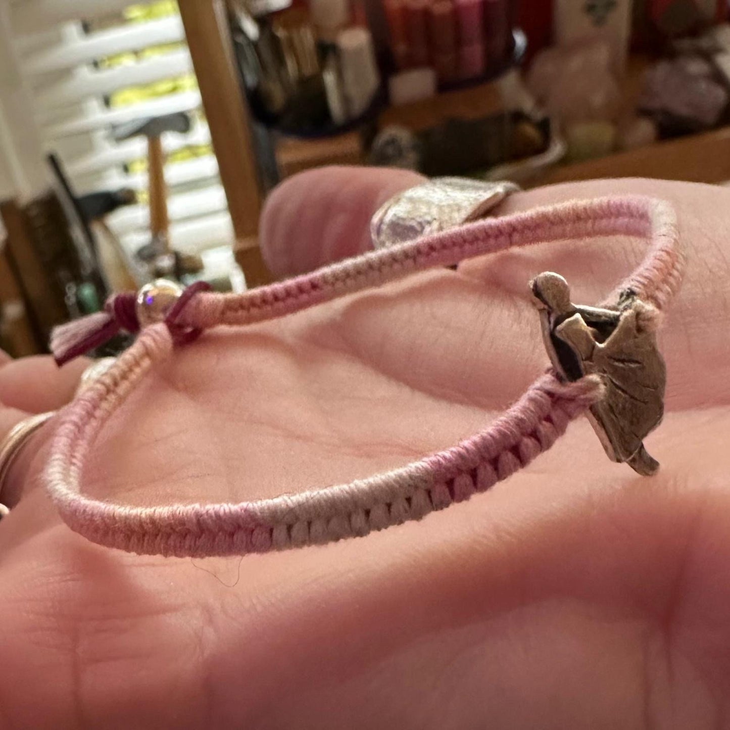 A gorgeous fine silver tiny dancer on a pretty pink leather, cotton and sterling silver friendship bracelet.
