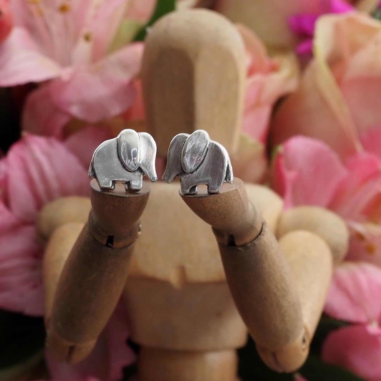 A pair of elegant elephant stud earrings handmade in fine silver with sterling silver posts.