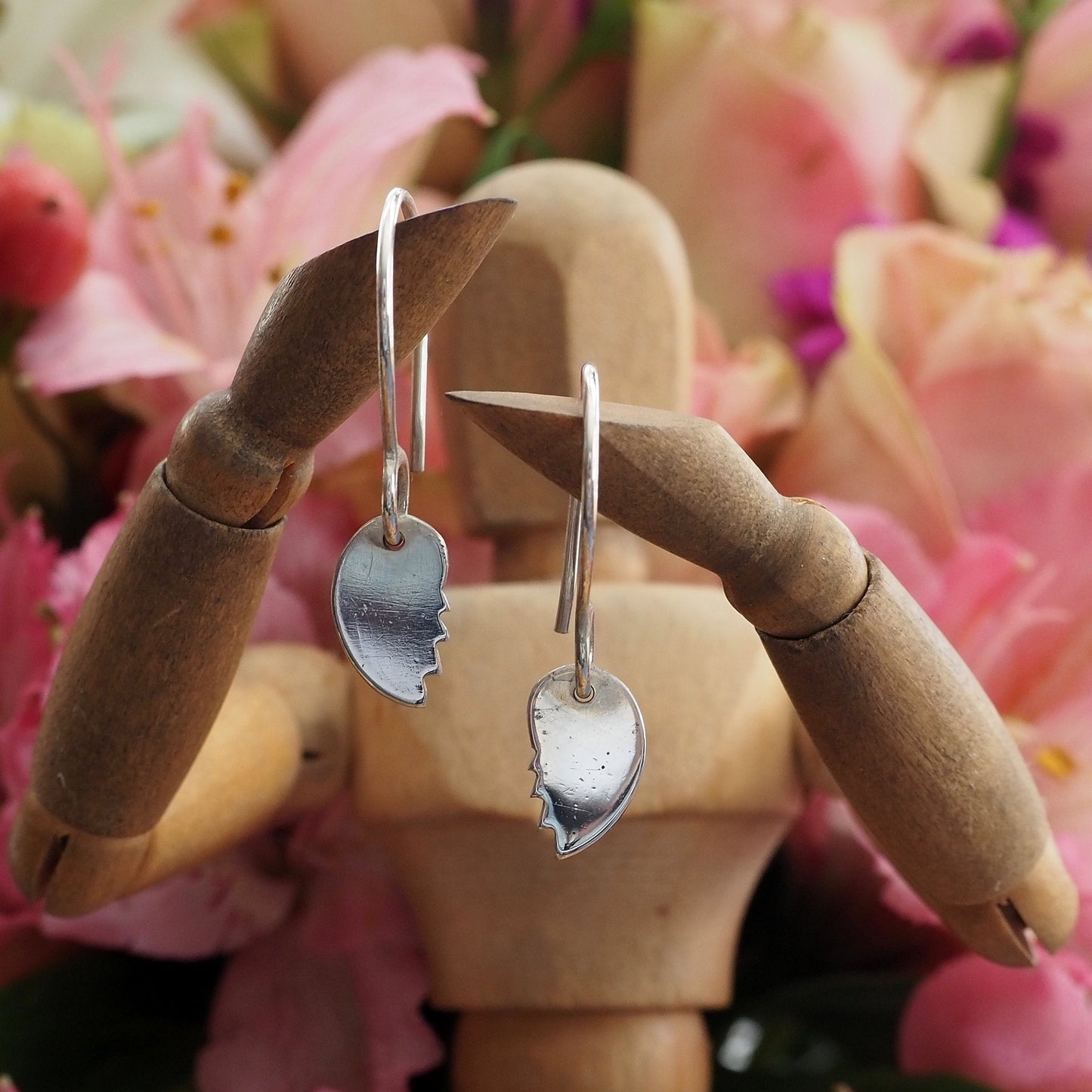 A pair of simple broken heart earrings handmade in fine silver on handmade sterling silver wires.