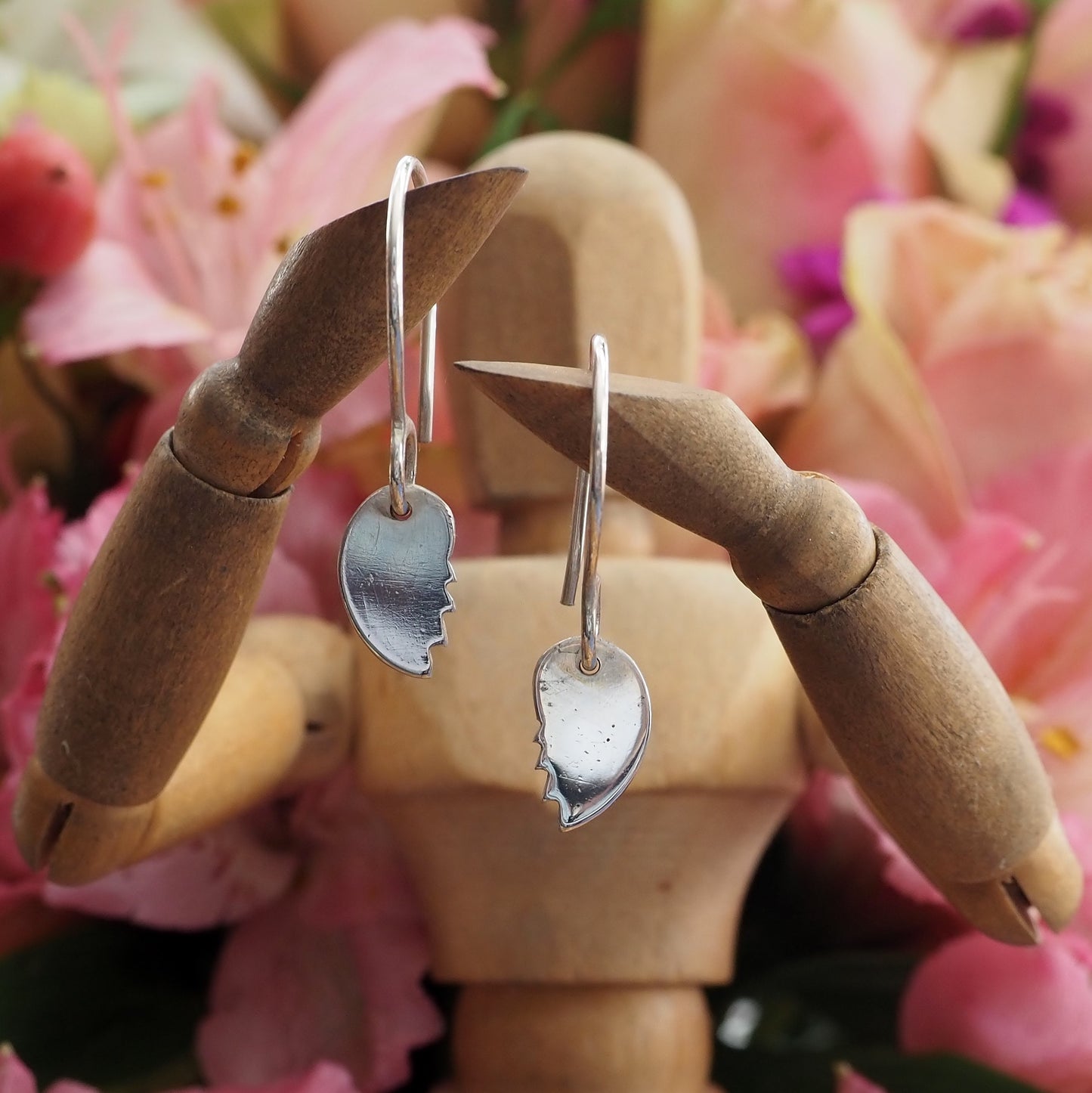 A pair of simple broken heart earrings handmade in fine silver on handmade sterling silver wires.