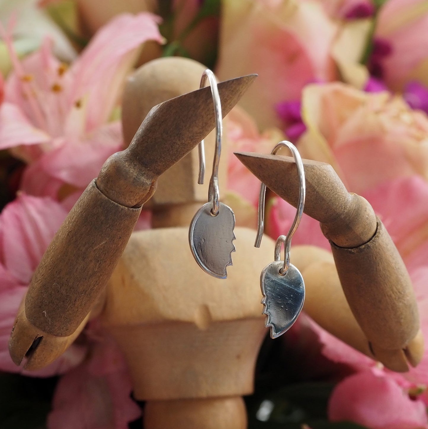 A pair of simple broken heart earrings handmade in fine silver on handmade sterling silver wires.