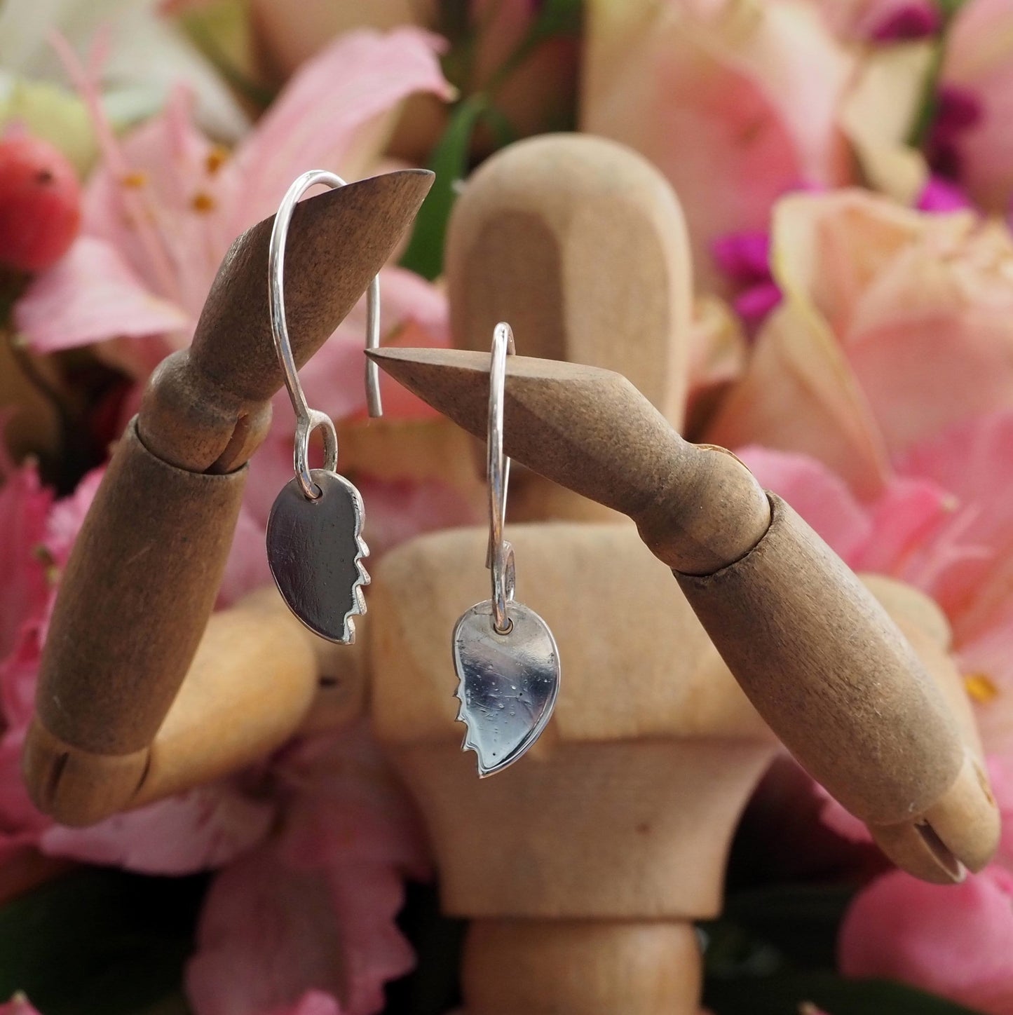 A pair of simple broken heart earrings handmade in fine silver on handmade sterling silver wires.