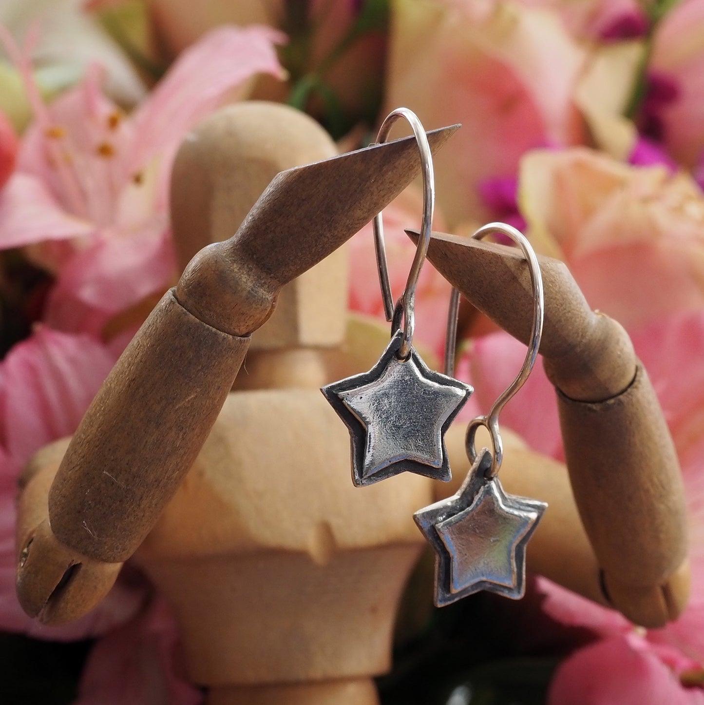 A gorgeously pair of silver hand made star earrings.
